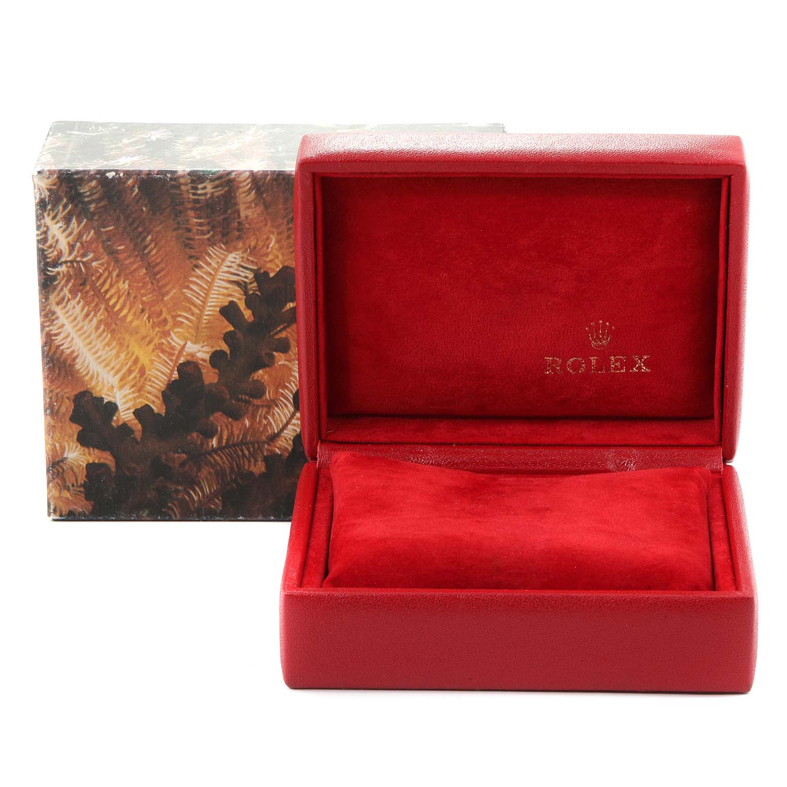 This image shows an open red Rolex watch box with a cushion inside, sans the President model watch.