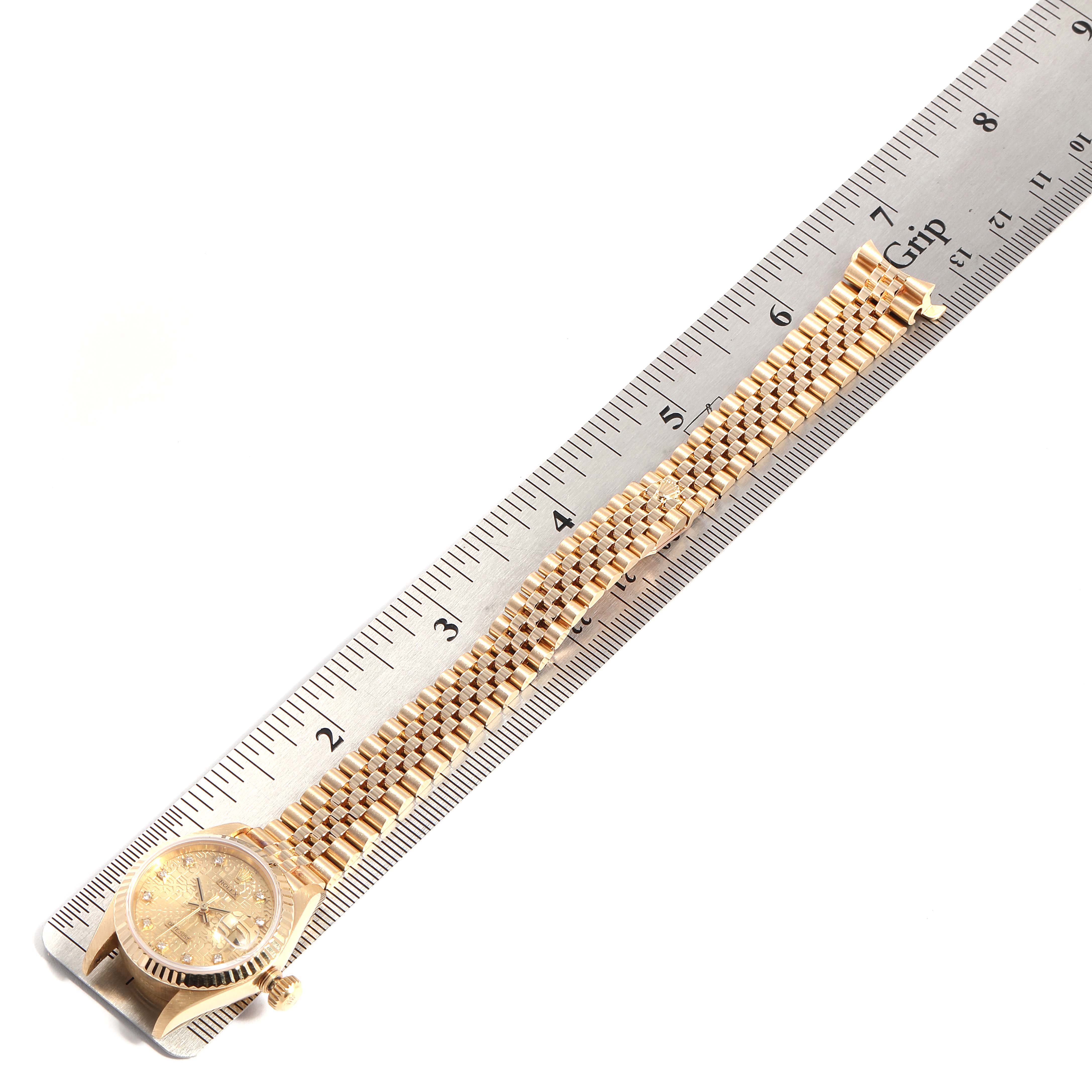 The Rolex President 69178 Women
s Yellow Gold Champagne Dial 69178 Women
s Yellow Gold Champagne Dial model watch is displayed with its dial, crown, and bracelet alongside a ruler for scale.