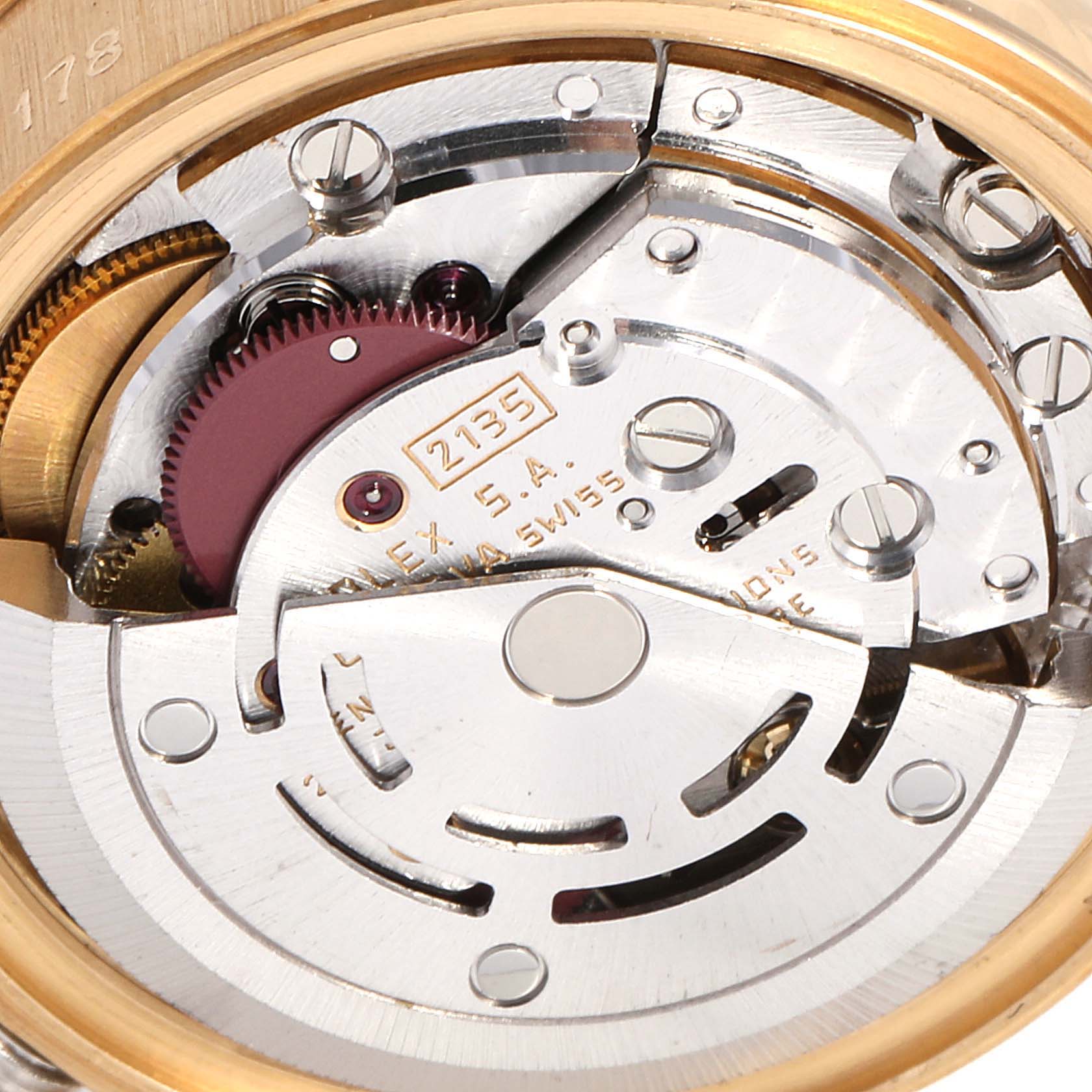 The image shows the inner mechanism of a Rolex President 69178 Women
s Yellow Gold Champagne Dial 69178 Women
s Yellow Gold Champagne Dial model watch, angled to highlight the movement components.
