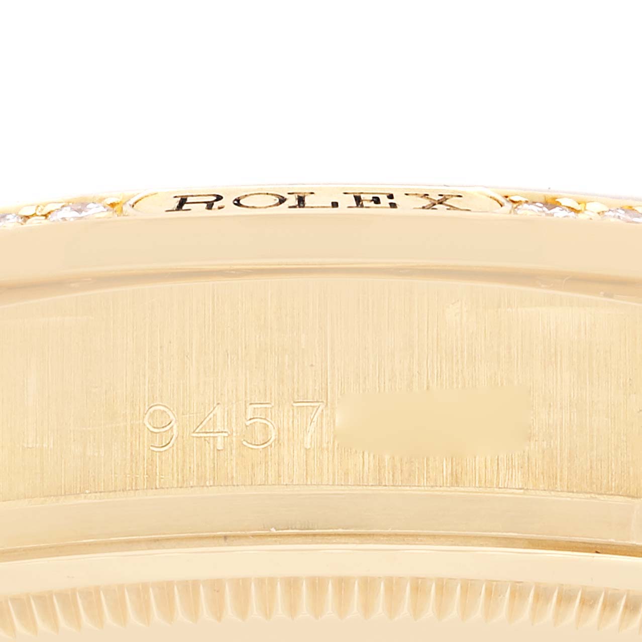 The image shows a close-up side view of the case, focusing on the engraved serial number and part of the bezel of the Rolex President 18138 Men
s Yellow Gold Champagne Dial 18138 Men
s Yellow Gold Champagne Dial model.