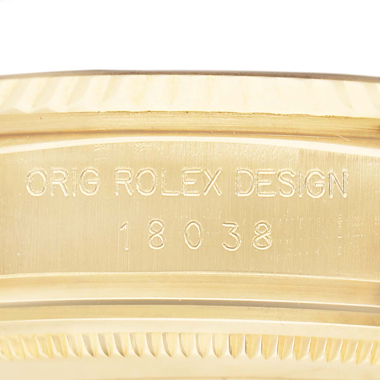 The image shows an engraving on the side of the Rolex President 18038 Men's Yellow Gold Champagne Dial model, highlighting its design number.