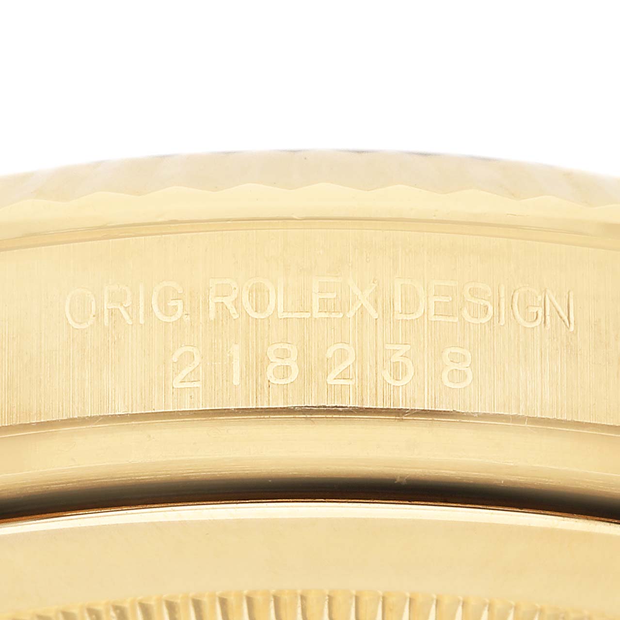 The image shows a close-up of the engraved side of a Rolex President 218238 Men's Yellow Gold White Dial watch, focusing on the model number.
