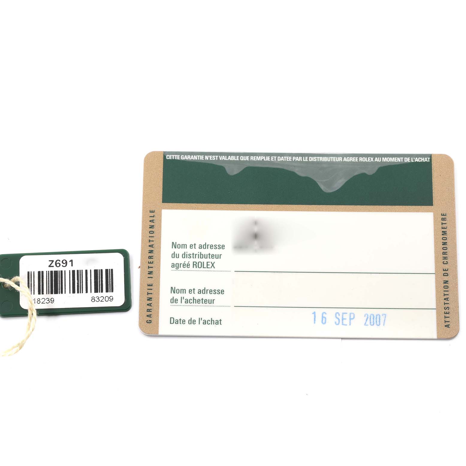 The image shows a warranty card and a tag for a President model Rolex watch.