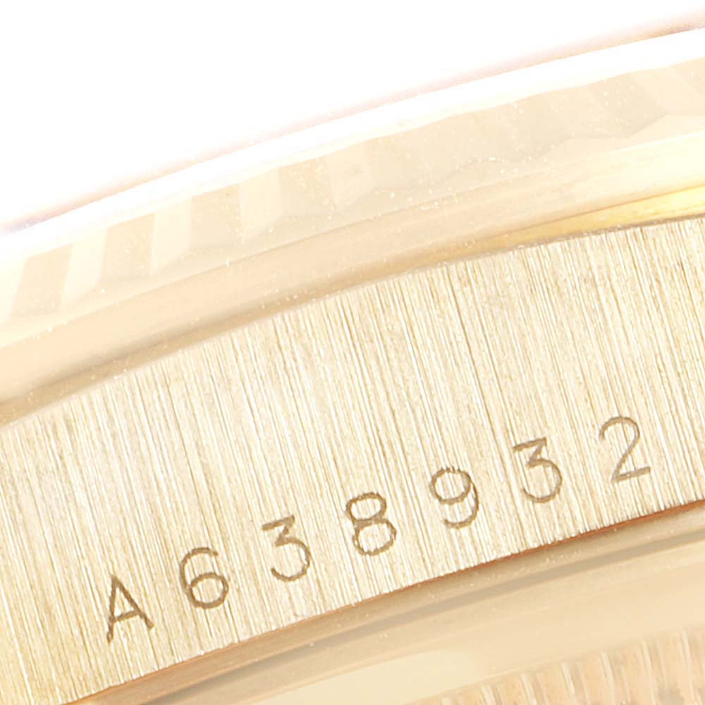 This close-up image of the Rolex President 18238 Men
s Yellow Gold Champagne Dial 18238 Men
s Yellow Gold Champagne Dial model shows the serial number engraved on the inner rim of the watch case.