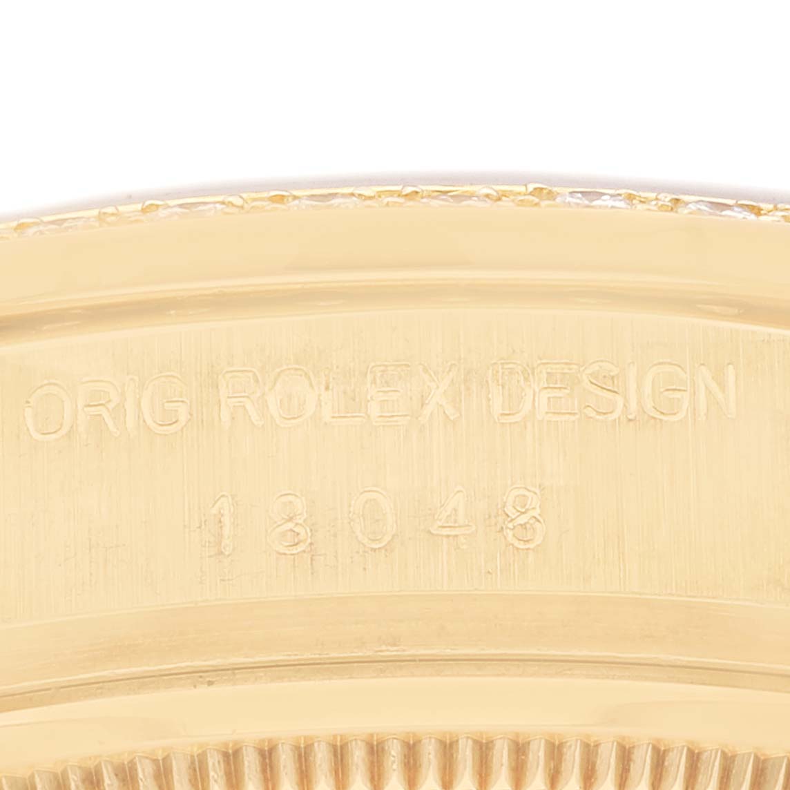 The image shows a close-up of the case back and bezel edge of the Rolex President 18048 Men
s Yellow Gold Champagne Dial 18048 Men
s Yellow Gold Champagne Dial model, displaying the engraved design number.