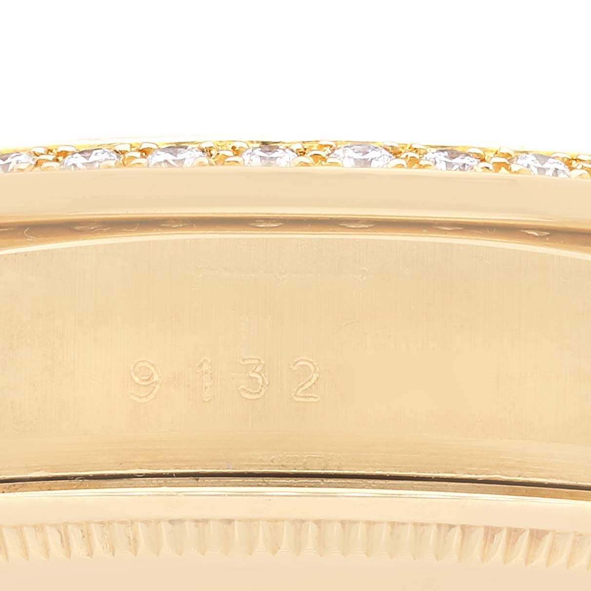 This image shows a close-up of the side and bezel of a Rolex President 18048 Men
s Yellow Gold Champagne Dial 18048 Men
s Yellow Gold Champagne Dial model, with visible serial numbers.