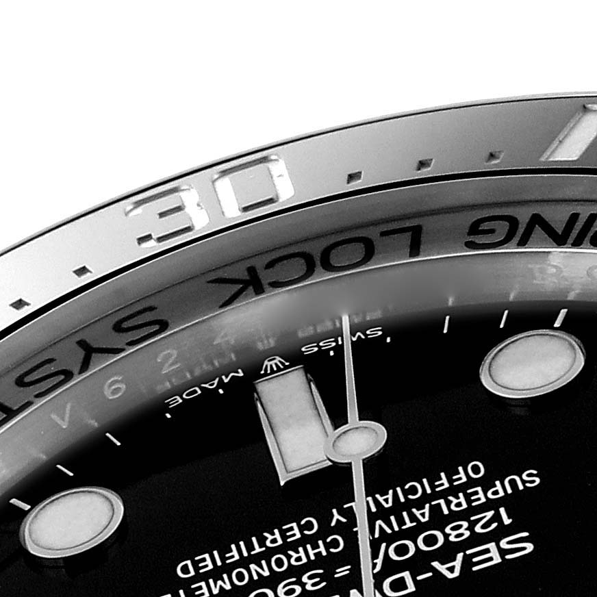This close-up image of a Rolex Sea-Dweller 126660 Men's Stainless Steel Black Dial 126660 Men's Stainless Steel Black Dial watch shows part of the bezel with the "30" marker and a section of the dial with the hour markers.
