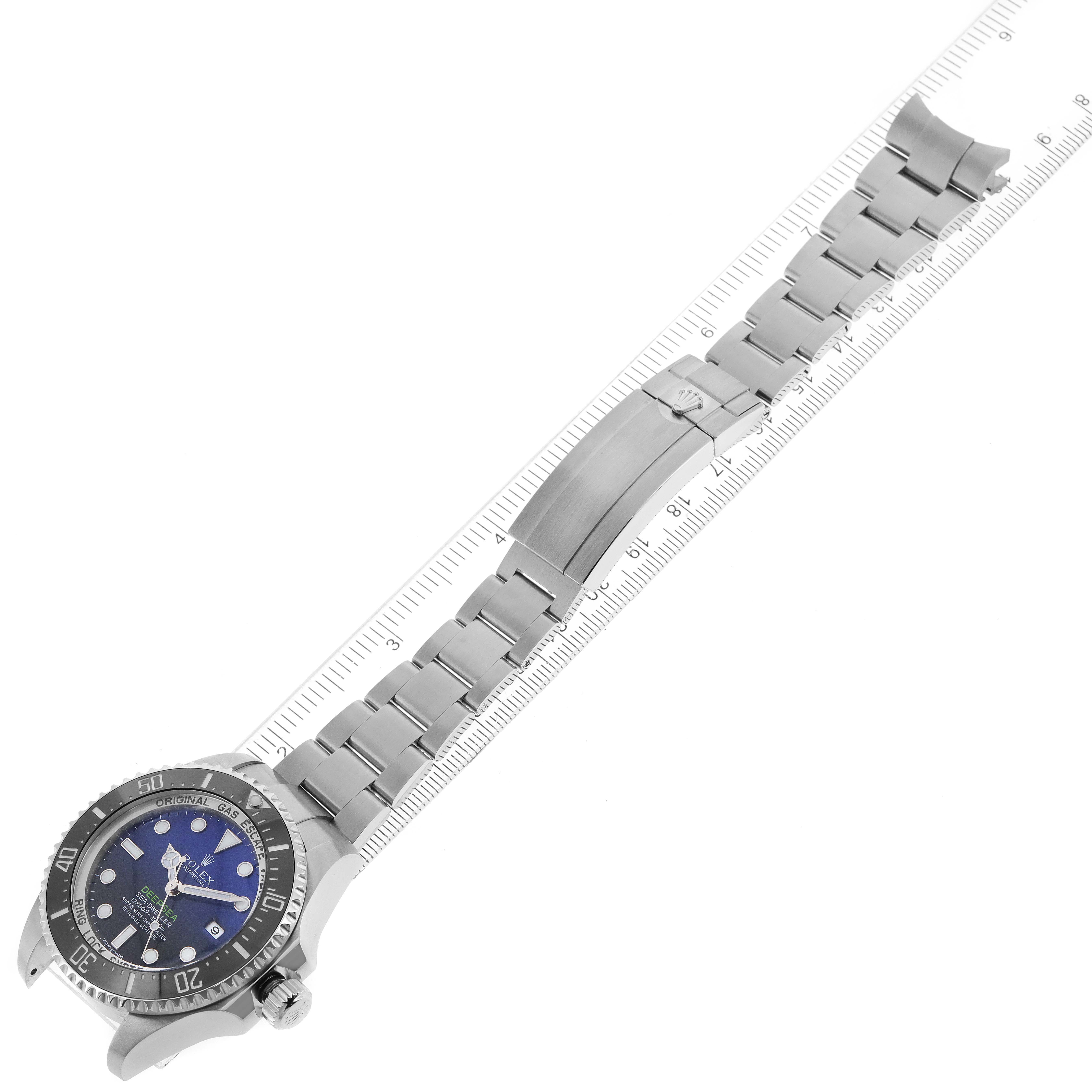The image shows a top-down view of a Rolex Sea-Dweller 116660 Men's Stainless Steel Blue Dial 116660 Men's Stainless Steel Blue Dial watch with its bracelet extended and aligned beside a ruler.