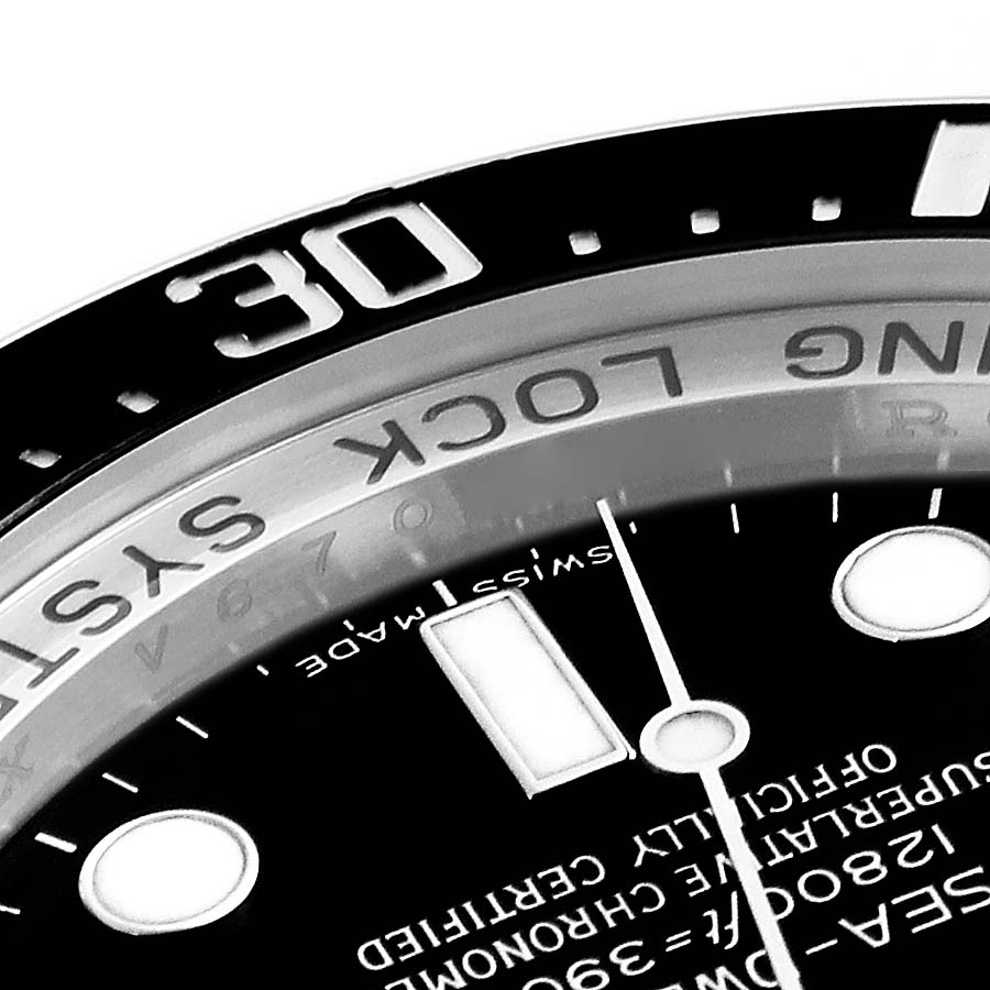 This close-up shows the bezel, part of the dial, and text on the Rolex Sea-Dweller 116660 Men
s Stainless Steel Black Dial 116660 Men
s Stainless Steel Black Dial watch.