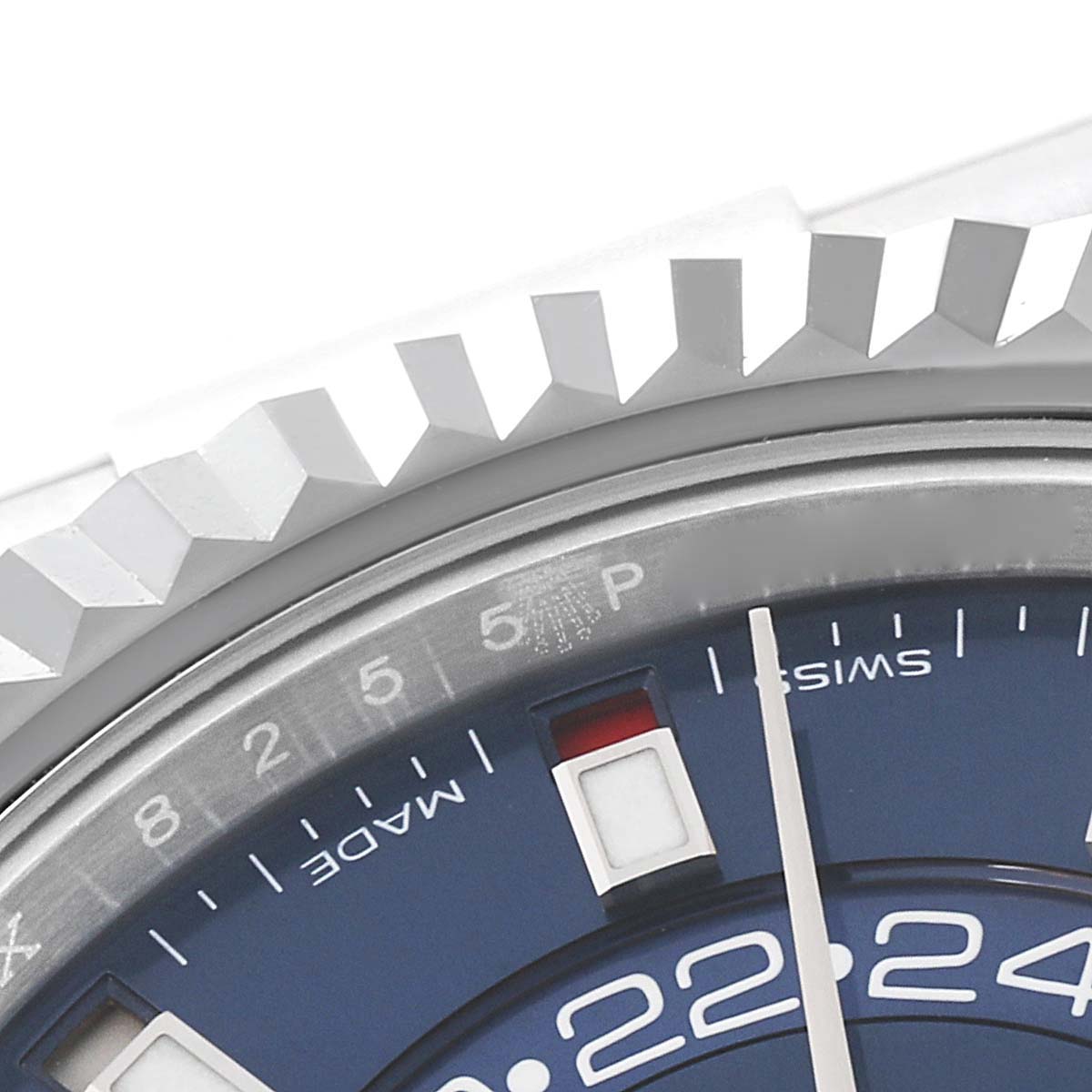 The image shows a partial close-up of the Rolex Sky-Dweller 326934 Men
s Stainless Steel Blue Dial 326934 Men
s Stainless Steel Blue Dial
s fluted bezel and blue dial, focusing on the date indicator and inner ring.