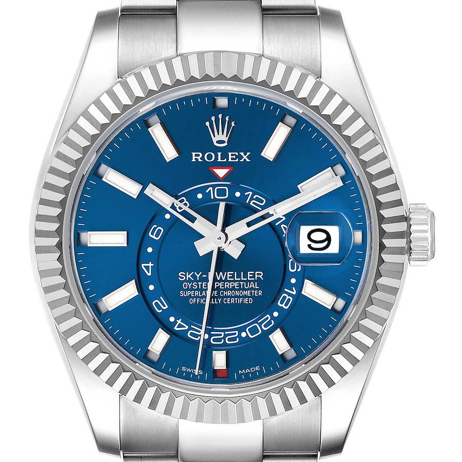 The Rolex Sky-Dweller is shown from a front angle, highlighting the blue dial, fluted bezel, and part of the bracelet.