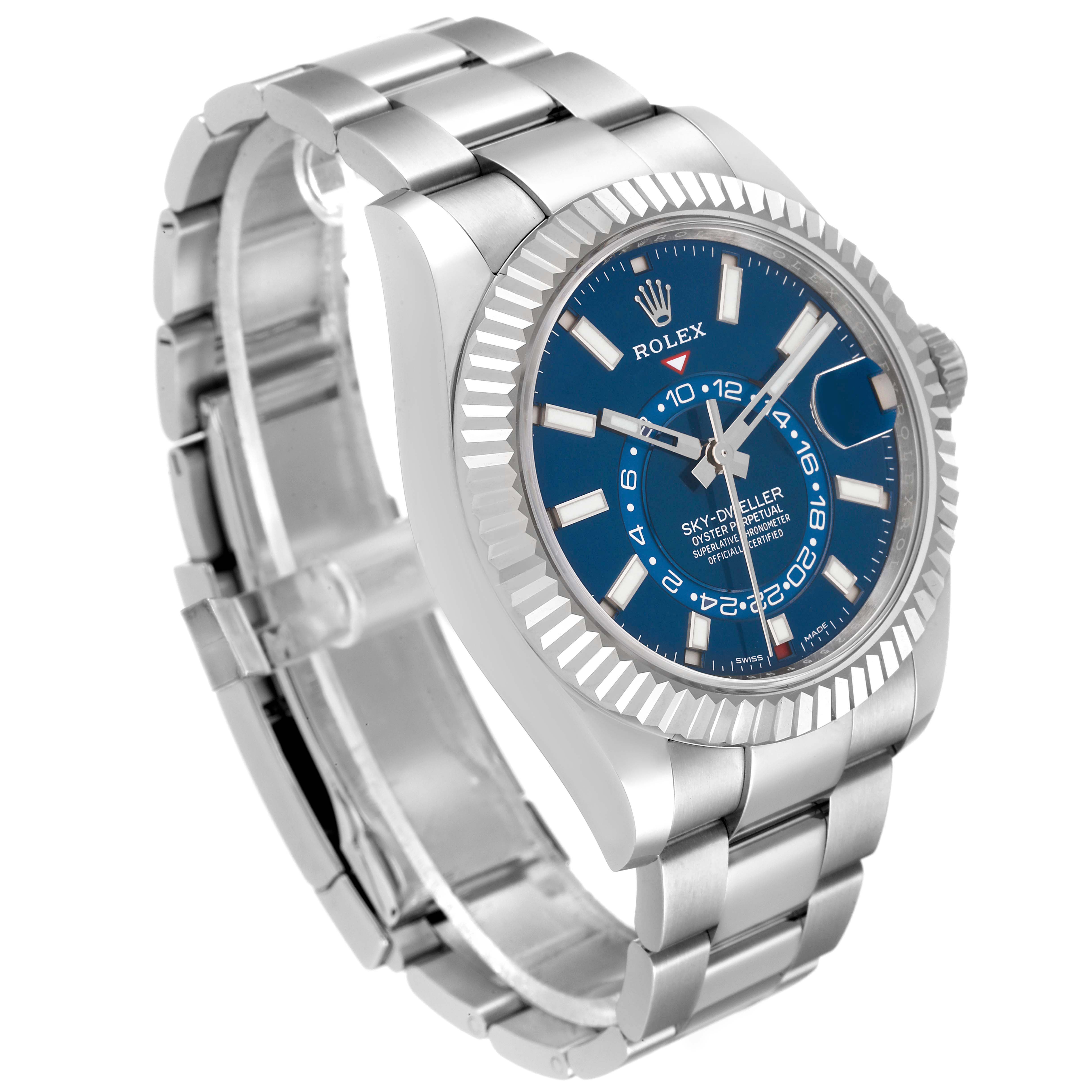 The Rolex Sky-Dweller 326934 Men
s Stainless Steel Blue Dial 326934 Men
s Stainless Steel Blue Dial watch is shown at an angled side view, displaying its blue dial, fluted bezel, and stainless steel bracelet.