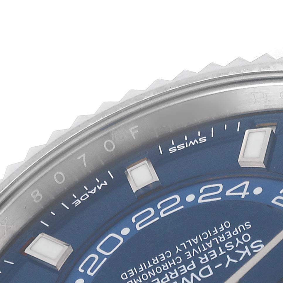 The image shows a close-up of the dial and bezel of the Rolex Sky-Dweller 326934 Men's Stainless Steel Blue Dial 326934 Men's Stainless Steel Blue Dial watch with a blue face.