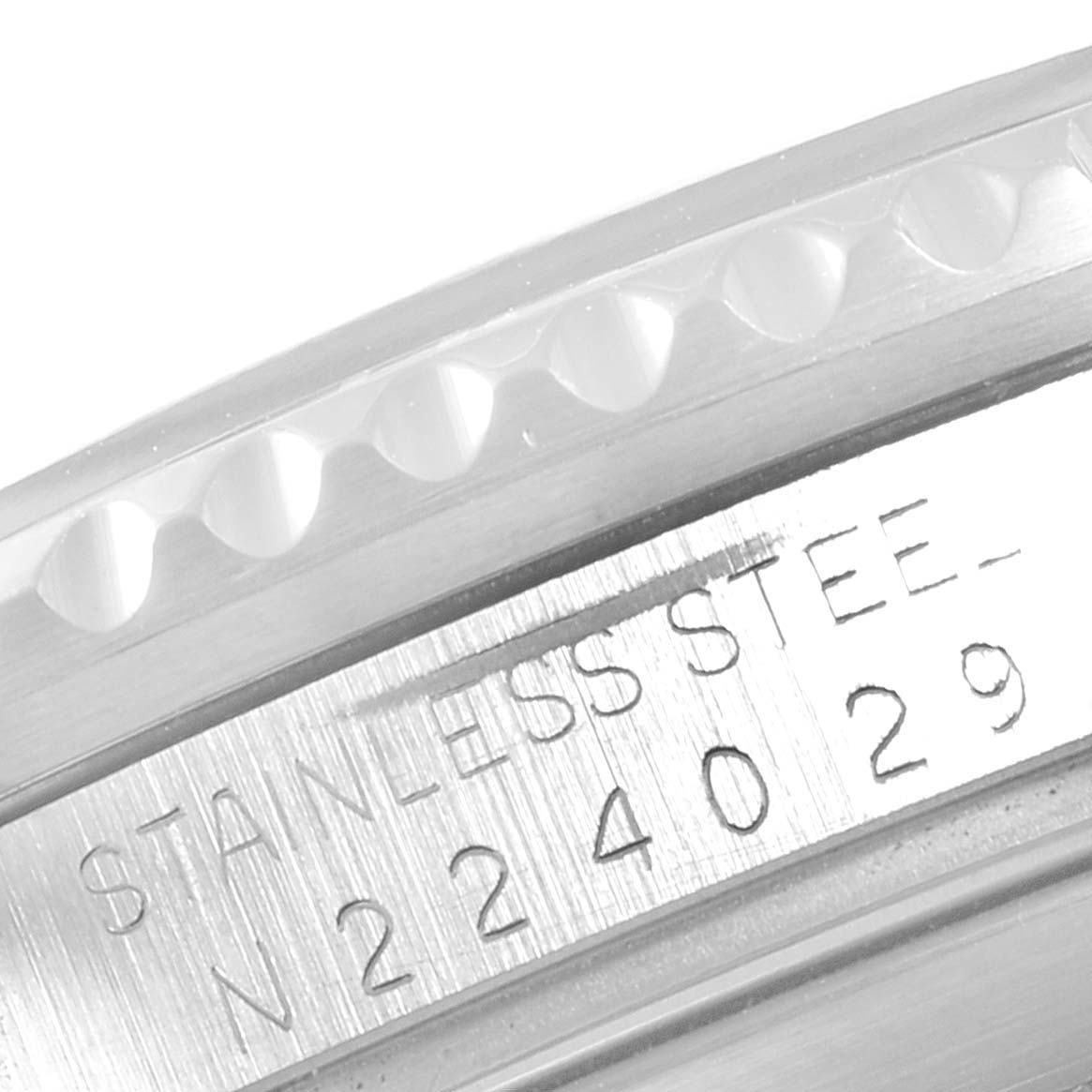 This image shows a close-up angle of the engraved bezel and serial number on a Rolex Submariner 16610 Men
s Stainless Steel Black Dial 16610 Men
s Stainless Steel Black Dial watch.