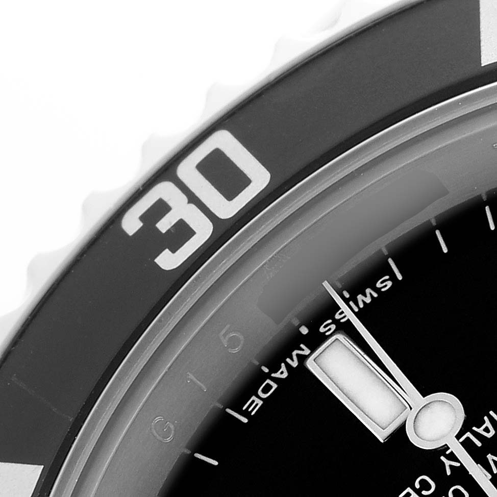 The image shows a close-up of the Rolex Submariner 14060 Men's Stainless Steel Black Dial’s bezel and part of the dial including the "30" minute mark.