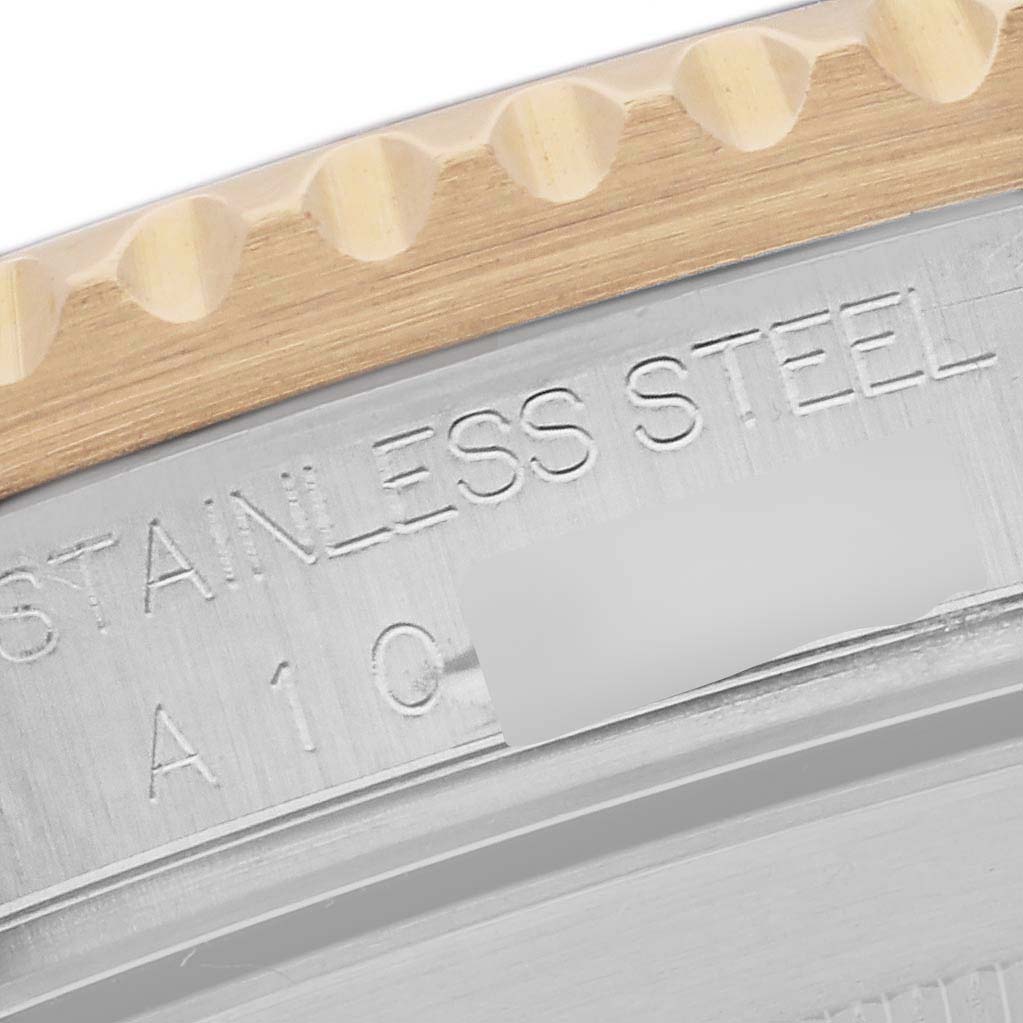 This close-up image shows a portion of the case back and bezel edge of a Rolex Submariner 16613 Men's Steel and Gold (two tone) Black Dial 16613 Men's Steel and Gold (two tone) Black Dial watch, highlighting the stainless steel engraving.