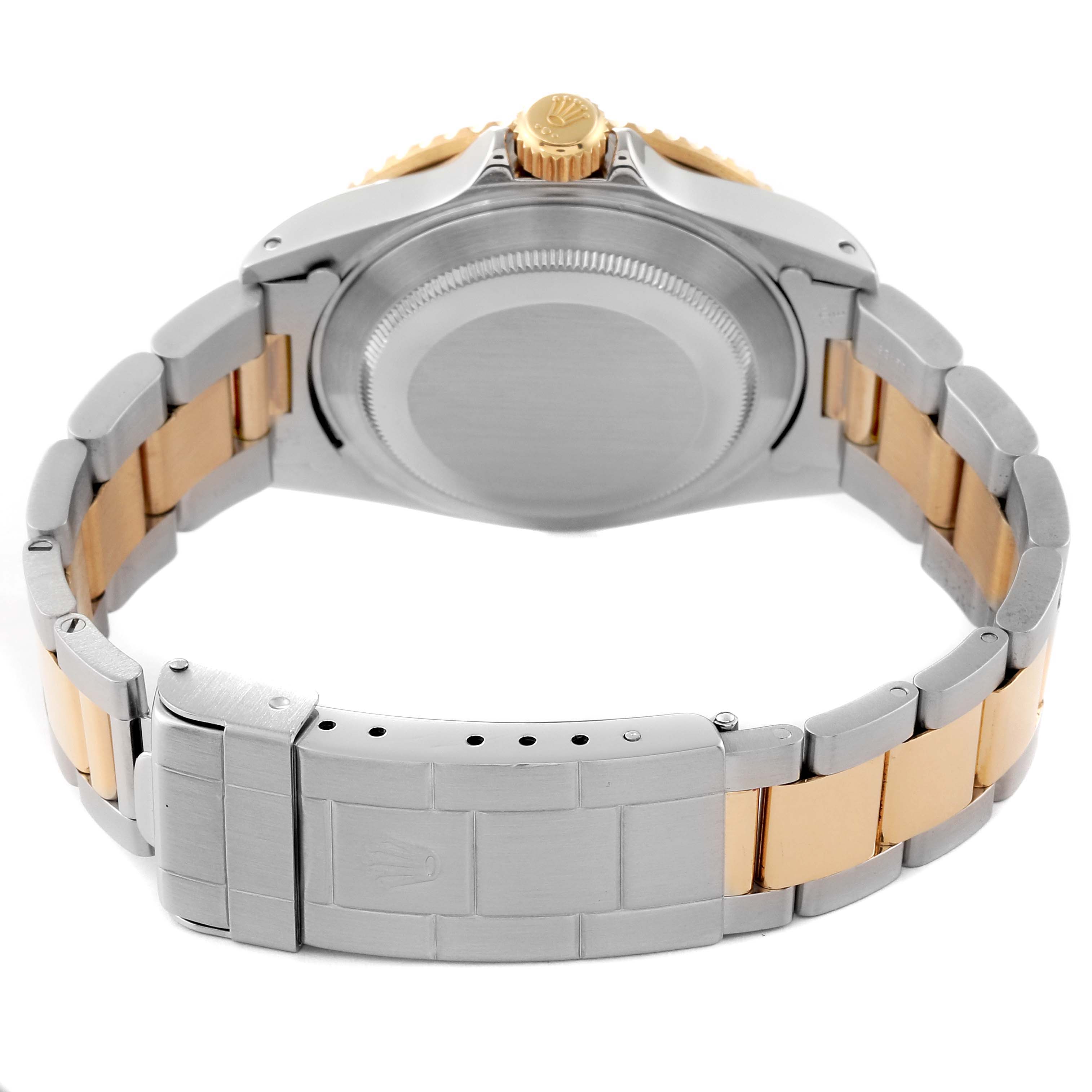 This image shows the backside of a Rolex Submariner 16613 Men's Steel and Gold (two tone) Black Dial 16613 Men's Steel and Gold (two tone) Black Dial watch, highlighting the clasp, bracelet, crown, and case back.