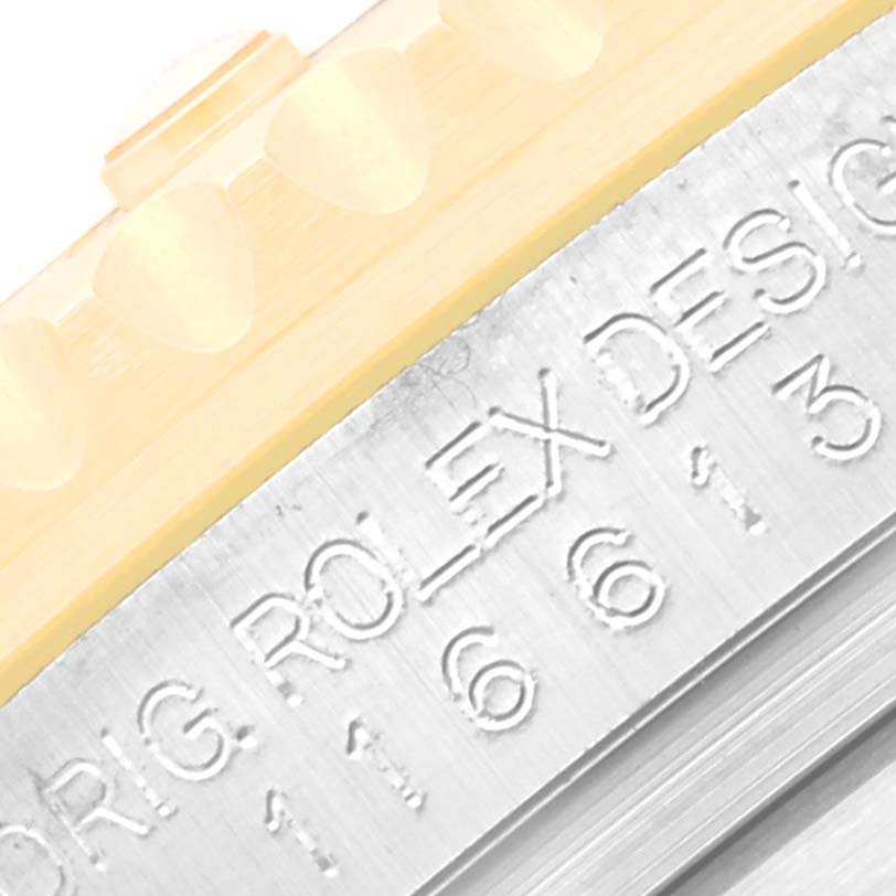 This close-up image shows the engraved bezel and part of the outer casing of a Rolex Submariner 116613LB Men's Steel and Gold (two tone) Blue Dial 116613LB Men's Steel and Gold (two tone) Blue Dial watch.