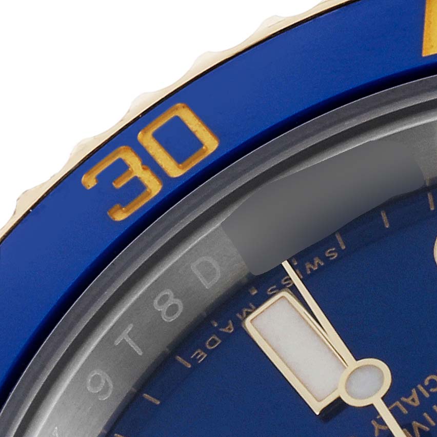 This close-up image shows the blue bezel and part of the dial of a Rolex Submariner 116613 Men's Steel and Gold (two tone) Blue Dial 116613 Men's Steel and Gold (two tone) Blue Dial watch.