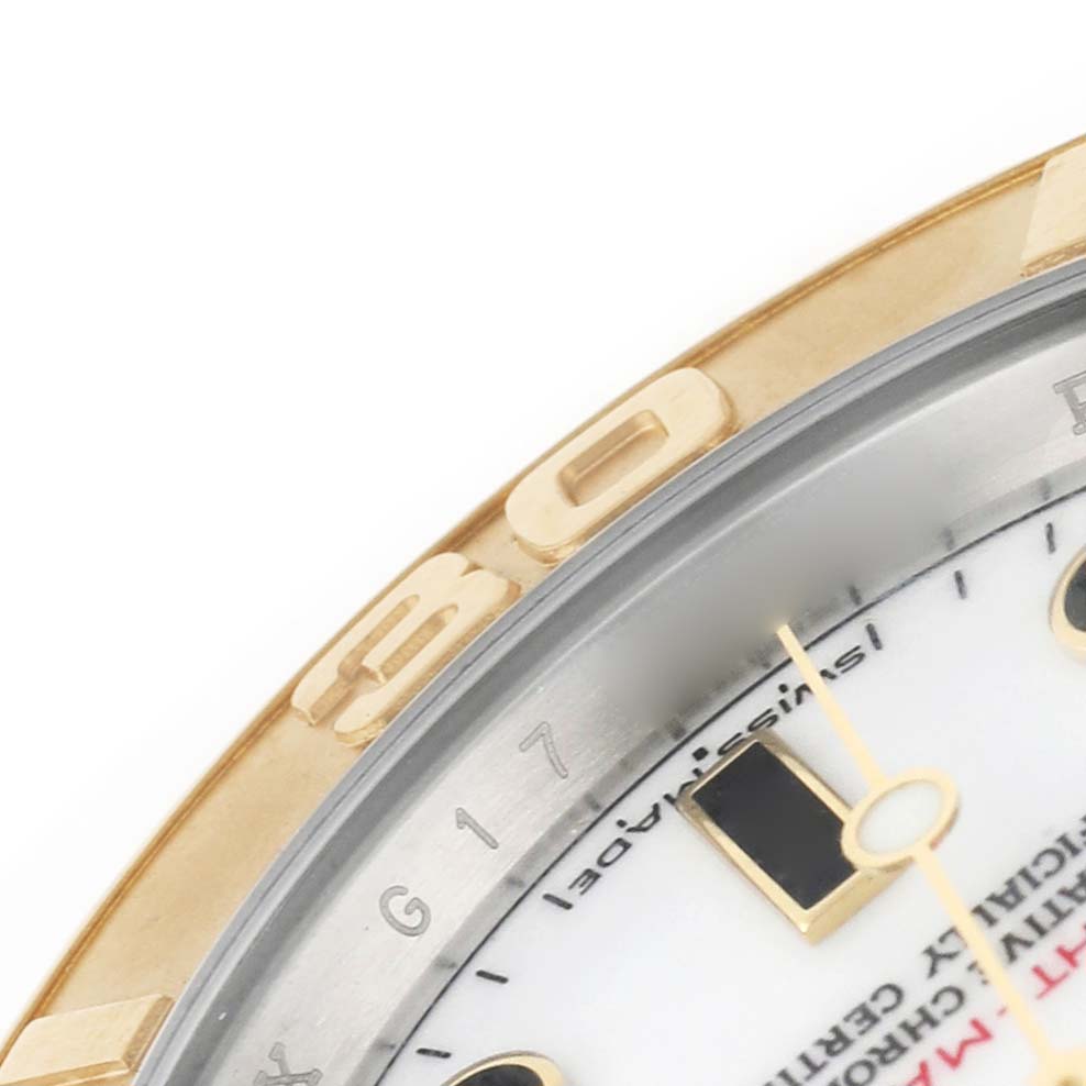 The image shows a close-up of the bezel and part of the dial of a Rolex Yacht-Master 16623 Men's Steel and Gold (two tone) White Dial watch.