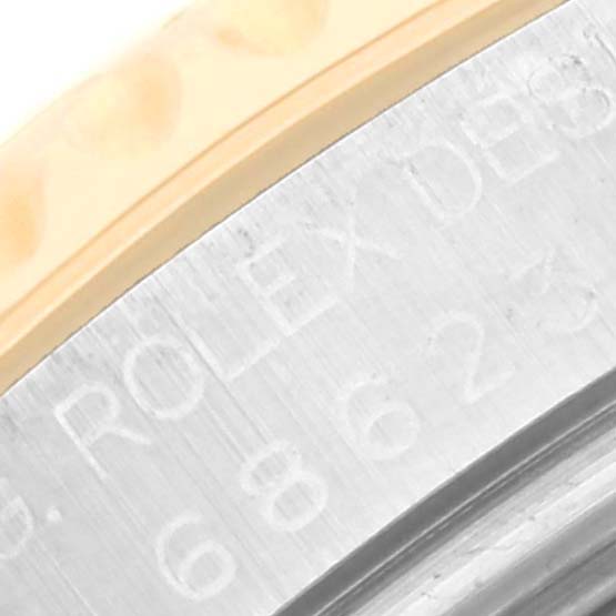 The image shows a close-up angle of the side engraving and part of the bezel on the Rolex Yacht-Master 68623 Men's Steel and Gold (two tone) White Dial 68623 Men's Steel and Gold (two tone) White Dial watch.