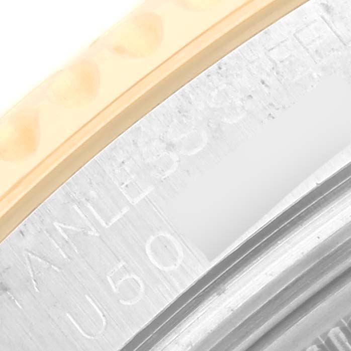 The close-up shows the edge of the bezel and part of the case of the Rolex Yacht-Master 68623 Men's Steel and Gold (two tone) White Dial 68623 Men's Steel and Gold (two tone) White Dial watch, including some engraved text.