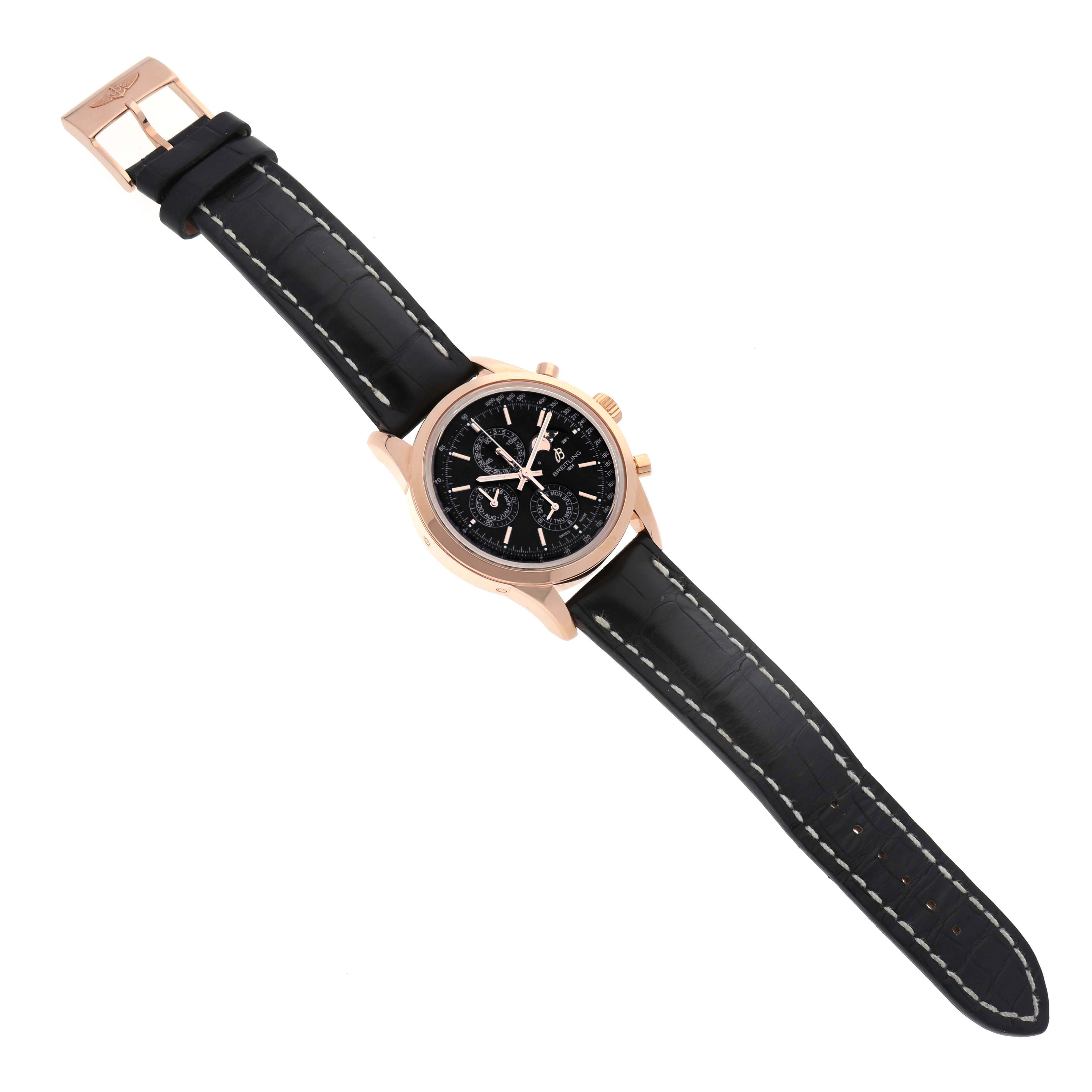 The Breitling Transocean R19310 Men's Rose Gold Black Dial watch is shown from a top-down angle, displaying its black dial, rose gold case, and black leather strap.