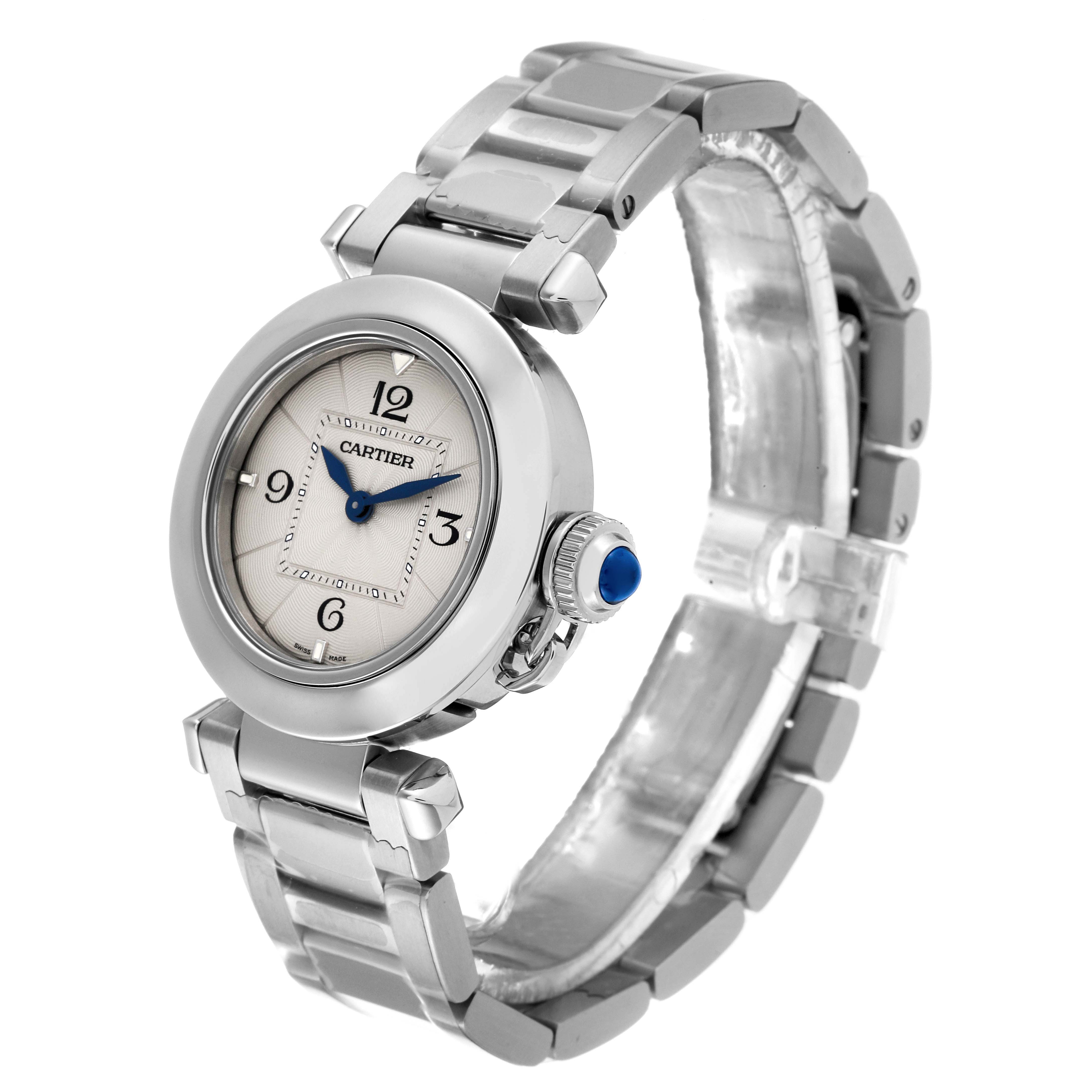 The Cartier Pasha WSPA0021 Women's Stainless Steel Silver Dial WSPA0021 Women's Stainless Steel Silver Dial watch is shown at an angle highlighting the face, bezel, bracelet, and crown with a blue cabochon.