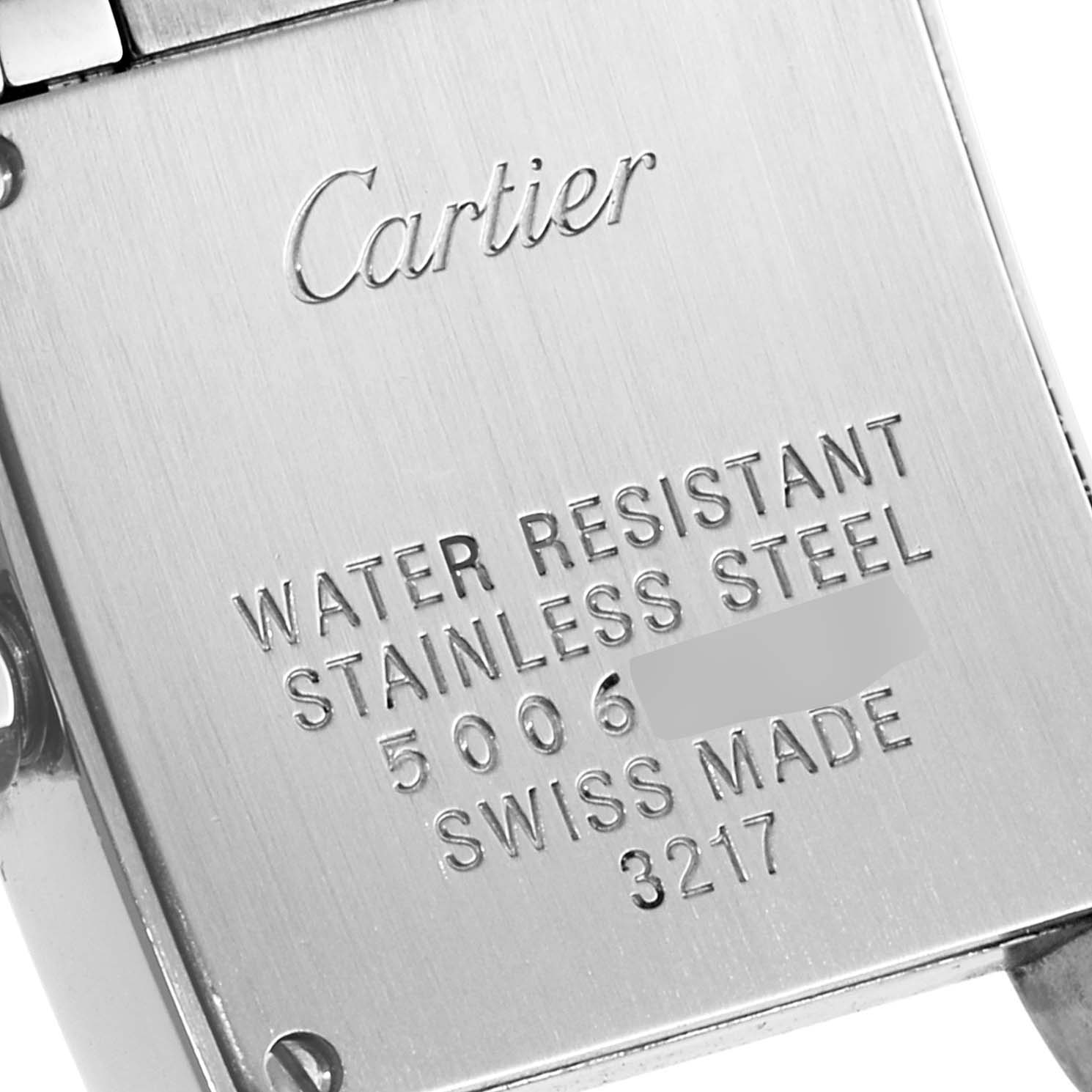 The image shows the back case of a Cartier Tank Francaise WE110006 Women's Stainless Steel Silver Dial WE110006 Women's Stainless Steel Silver Dial watch, highlighting its engravings and stainless steel material.