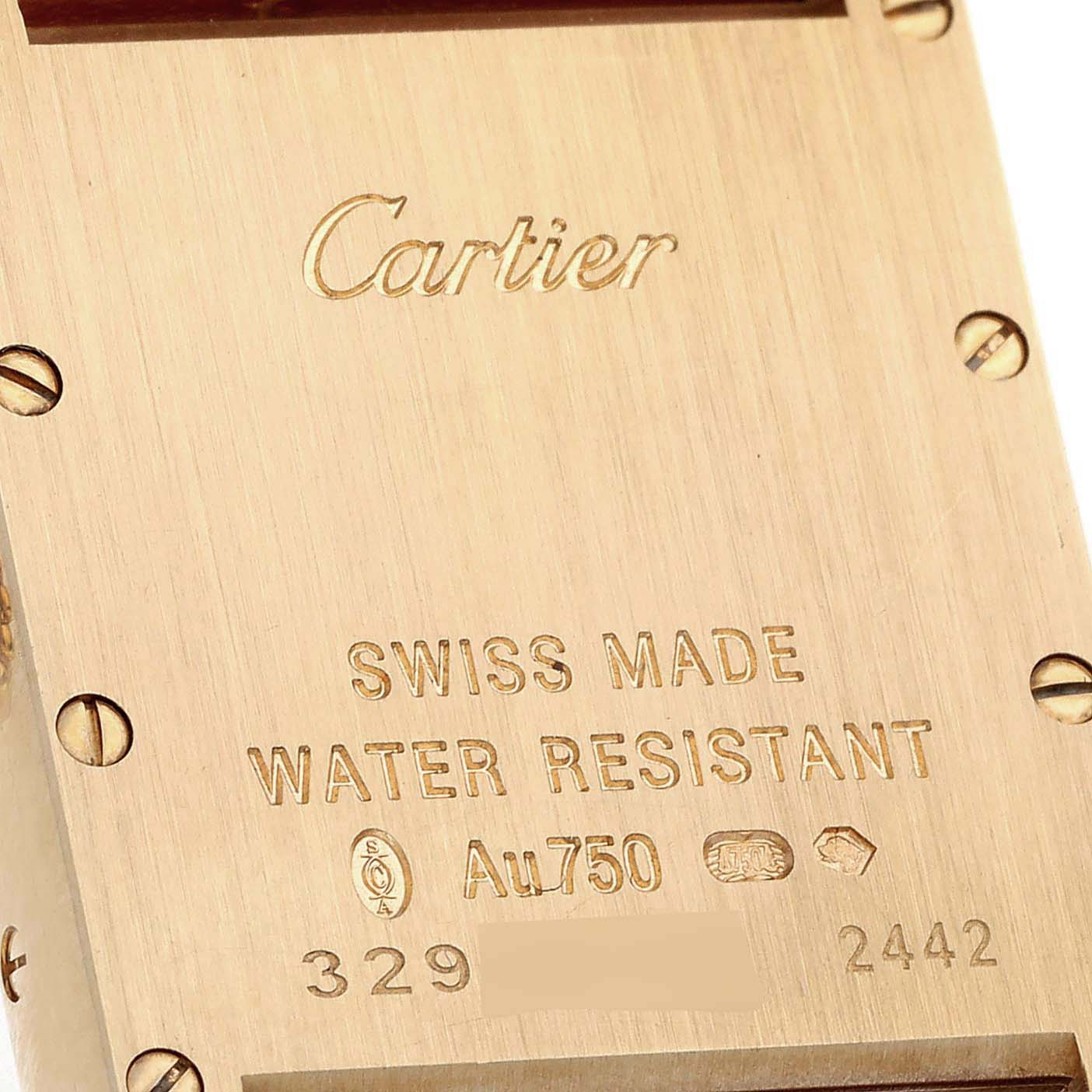 The image shows the back casing of a Tank Louis model watch by Cartier, highlighting engravings and craftsmanship details.