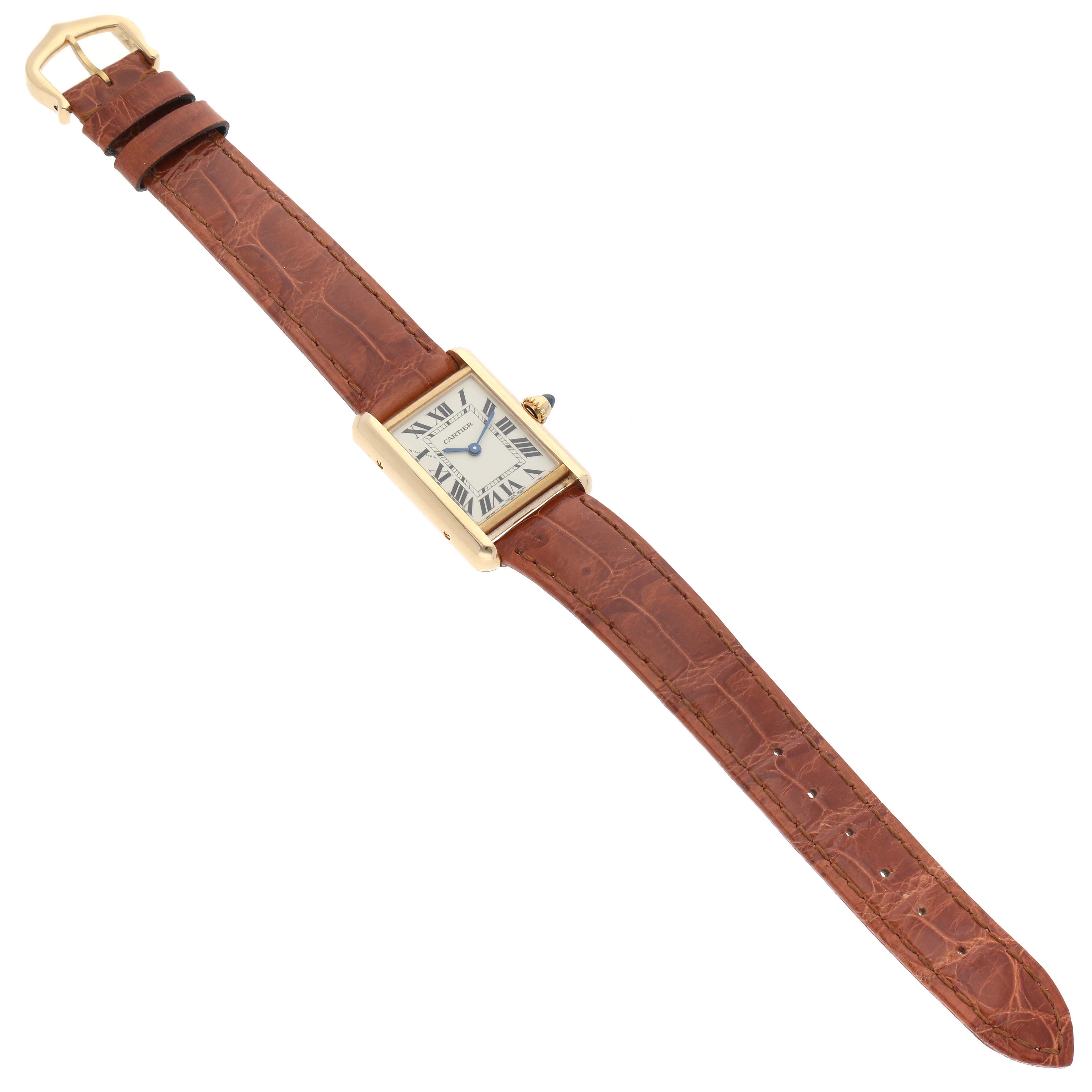 This image shows a Cartier Tank Louis W1529856 Women's Yellow Gold Silver Dial W1529856 Women's Yellow Gold Silver Dial model watch angled slightly from above, displaying the dial, strap, and buckle.