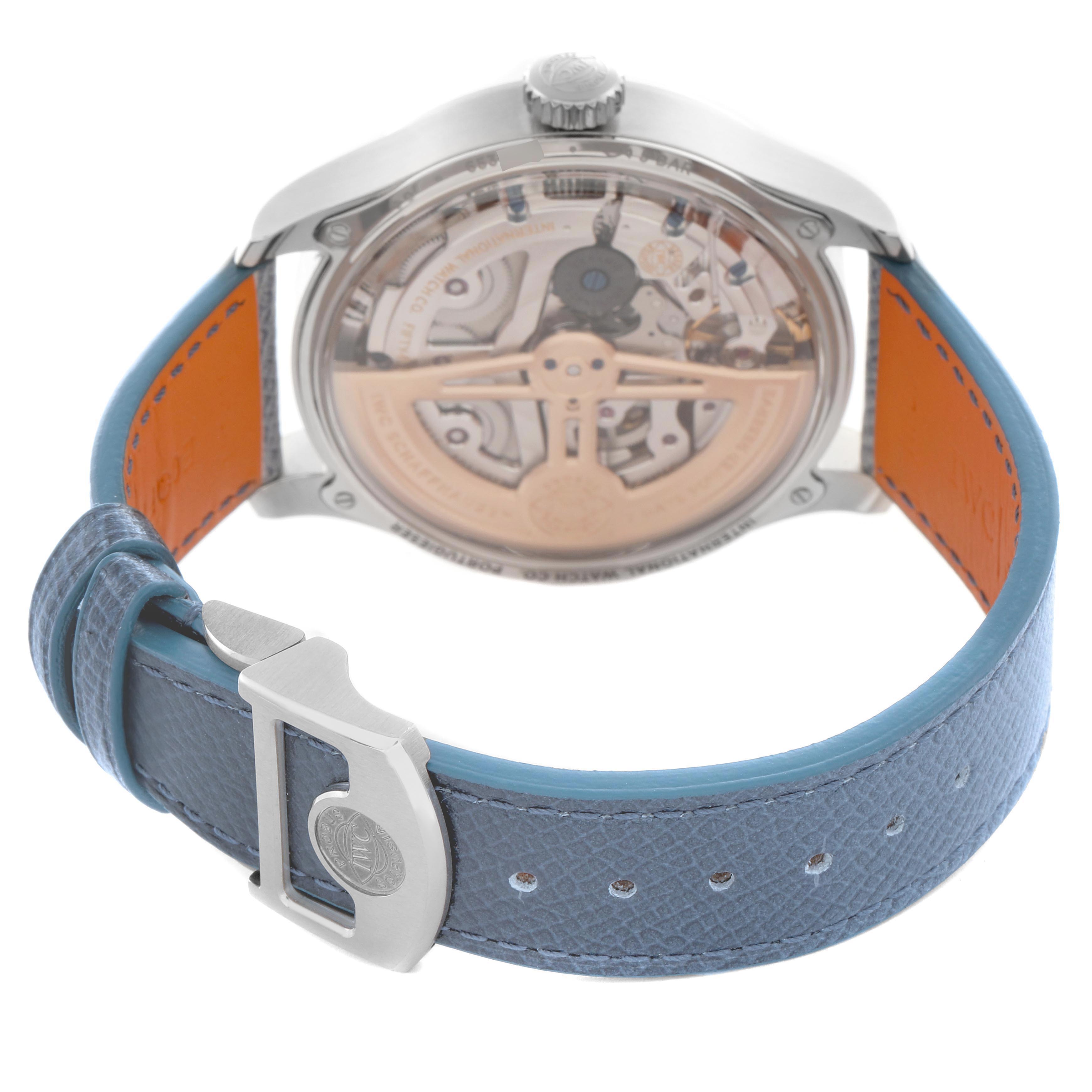 The image shows the back of the IWC Portuguese IW503703 Men's White Gold Blue Dial watch, highlighting the movement through the transparent case back and the blue strap with a clasp.