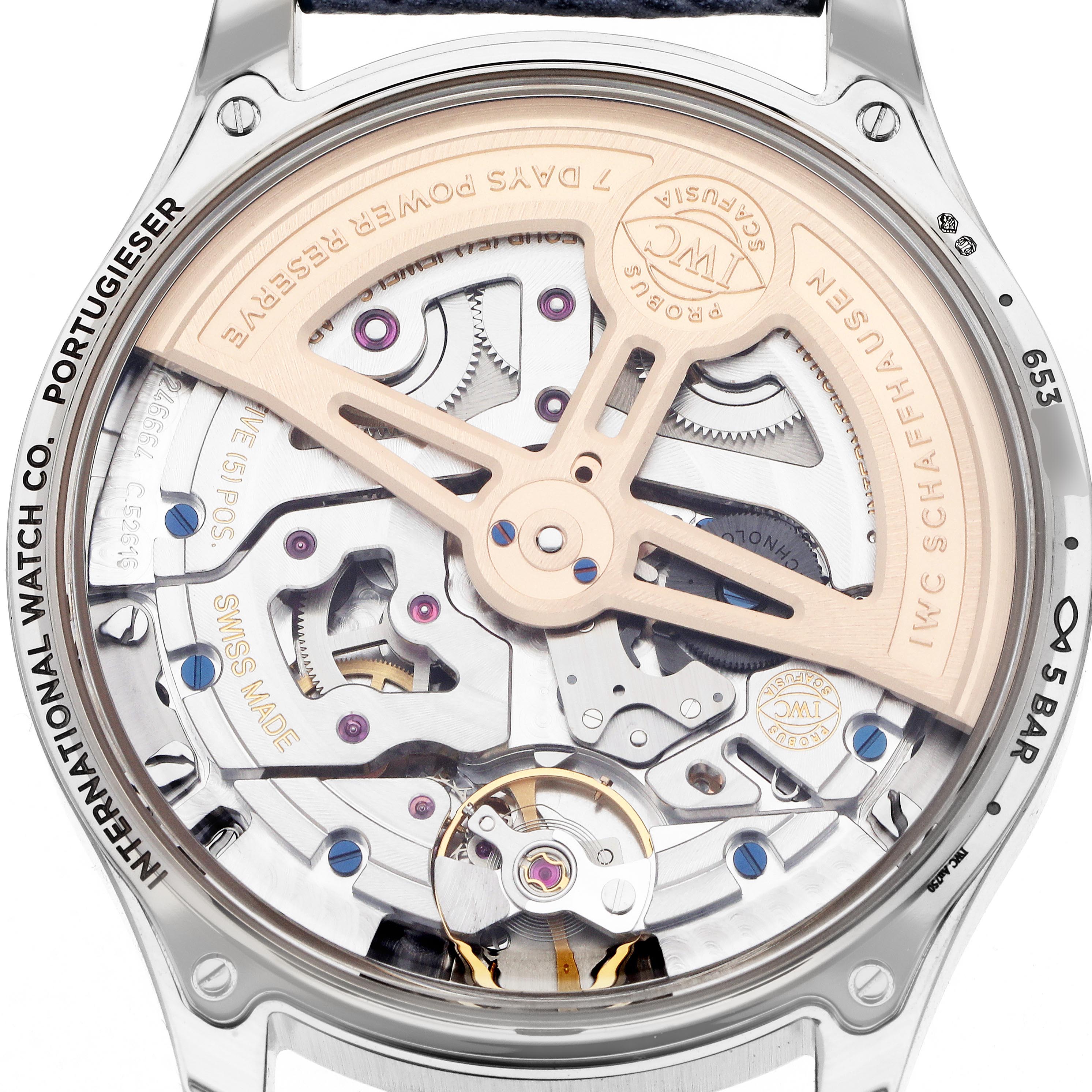 The image shows the case back of the IWC Portuguese IW503703 Men's White Gold Blue Dial IW503703 Men's White Gold Blue Dial model, highlighting the intricate movement and rotor.