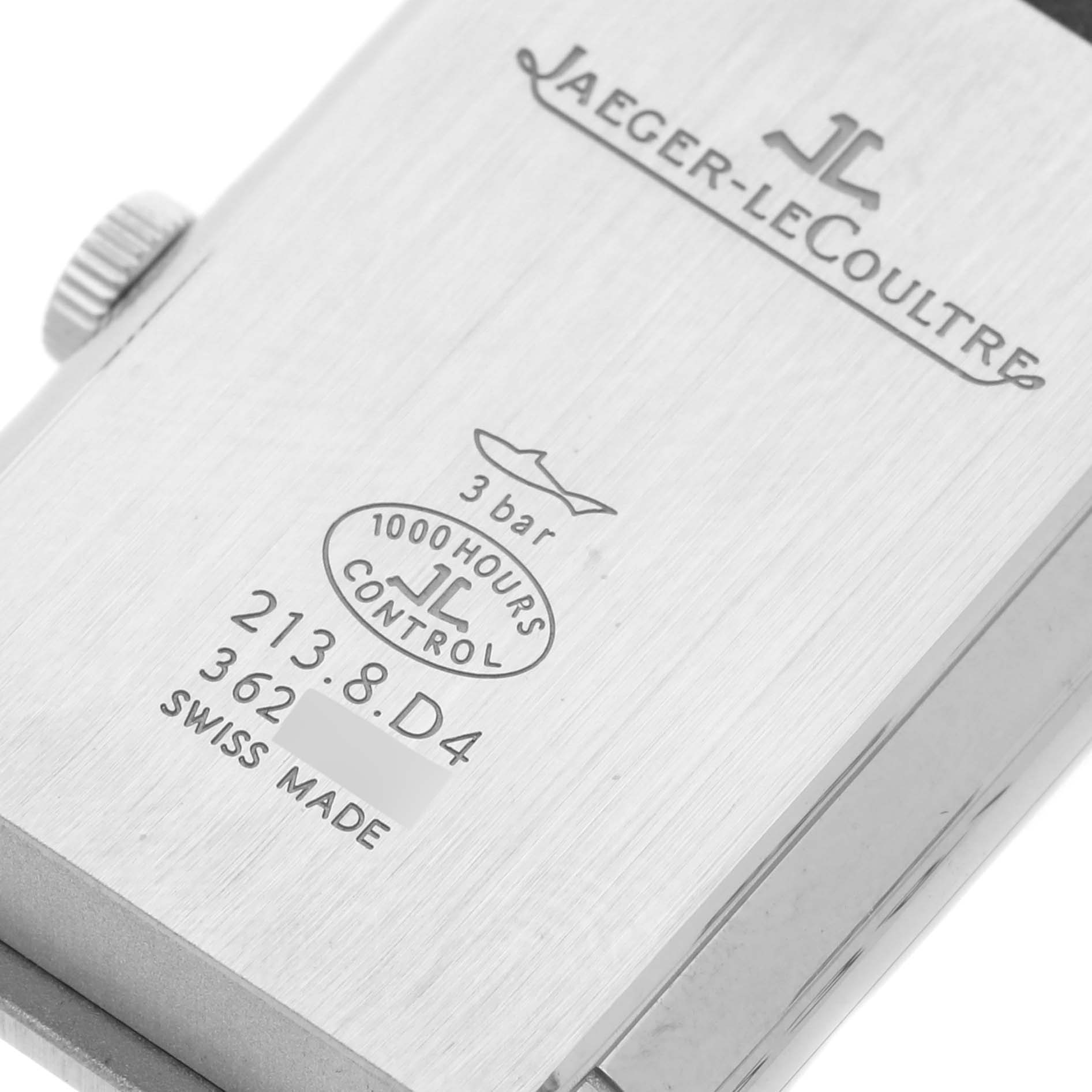 The image shows the back view of a Jaeger-LeCoultre Reverso watch, displaying branding, model information, and specifications.