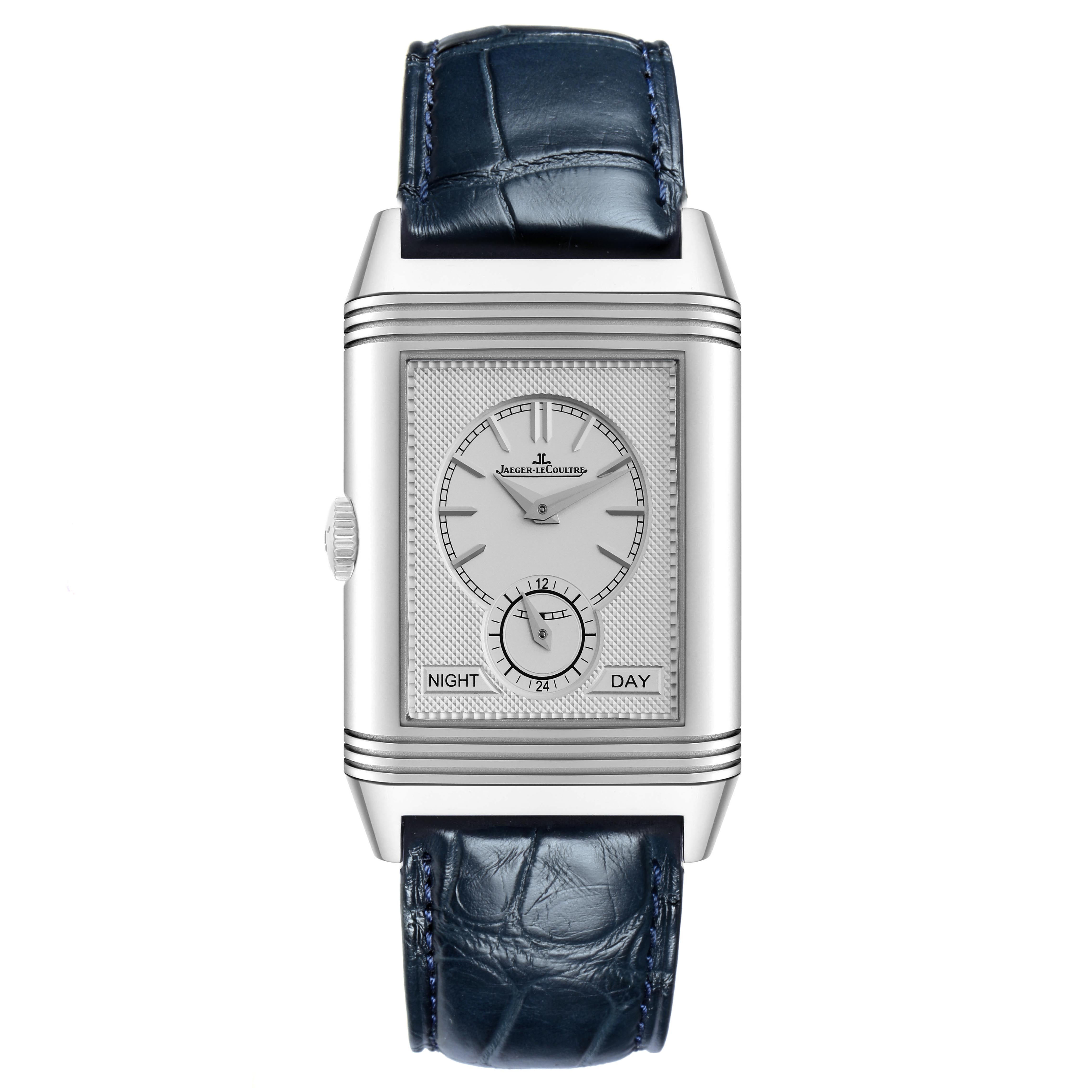 The Jaeger-LeCoultre Reverso watch is shown from the front, featuring its dial, case, crown, and blue strap.