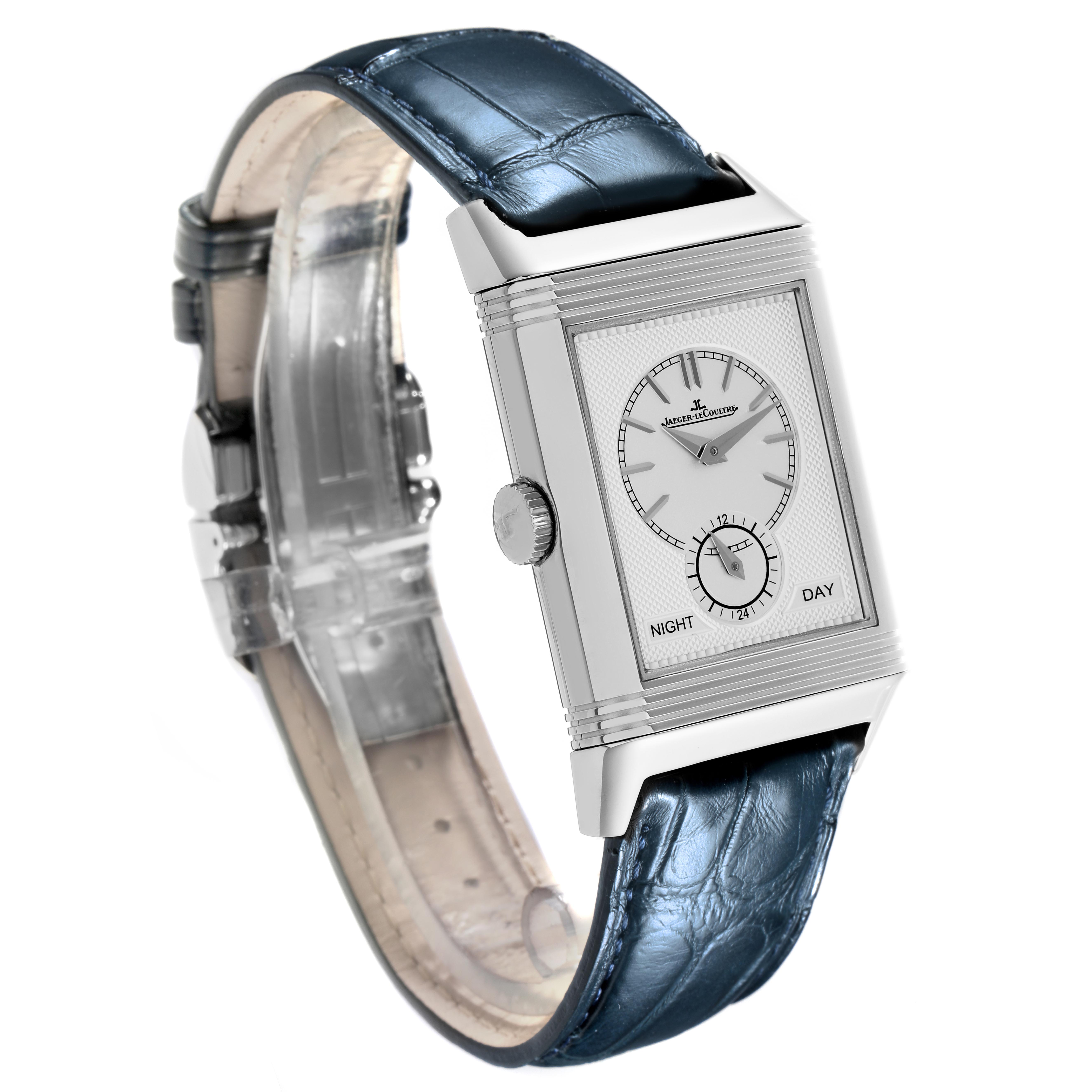 The Jaeger-LeCoultre Reverso watch is shown at a slight angle, highlighting the rectangular face, crown, and blue leather strap.