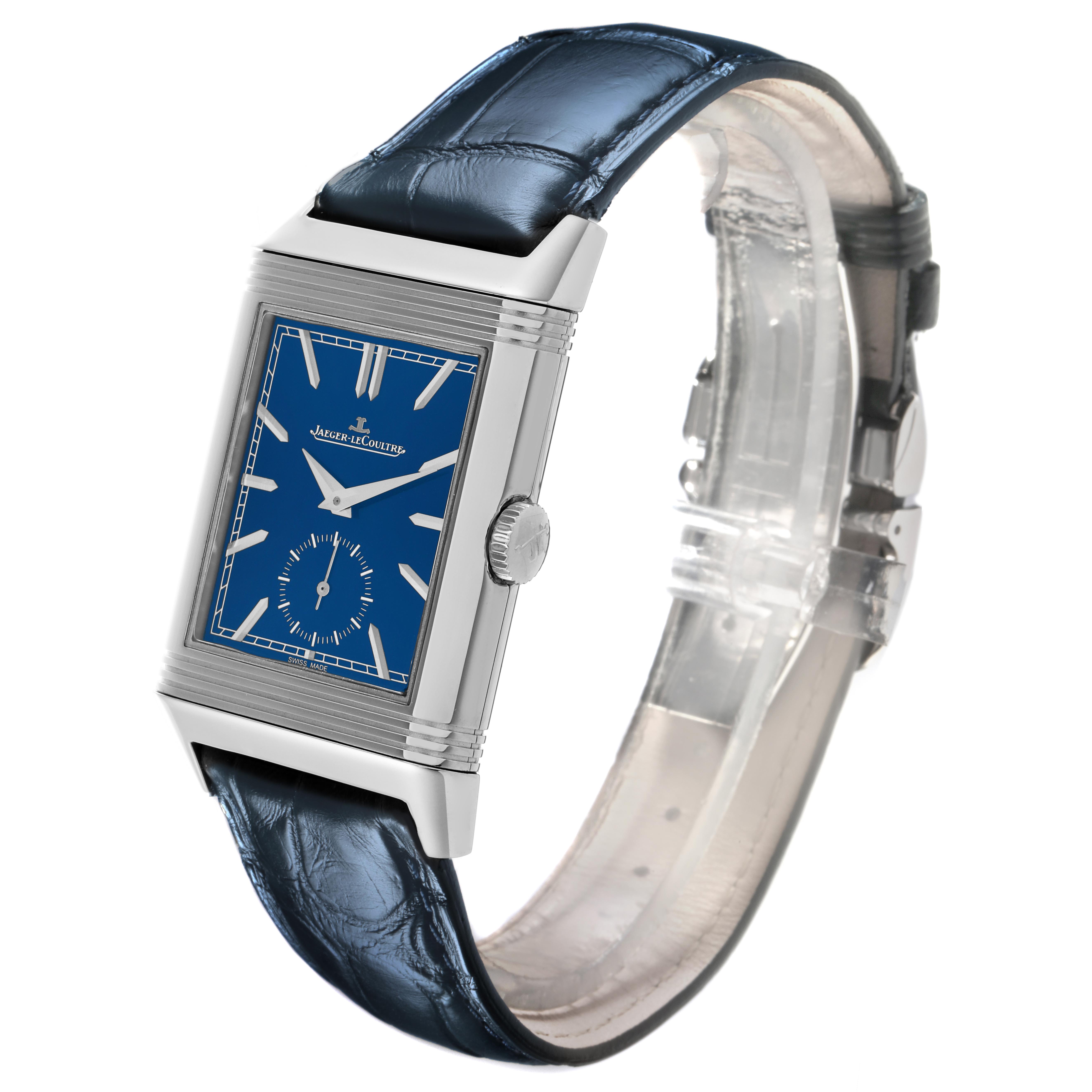 The Jaeger-LeCoultre Reverso model is shown at a 3/4 angle, highlighting its blue dial, case, crown, and leather strap.