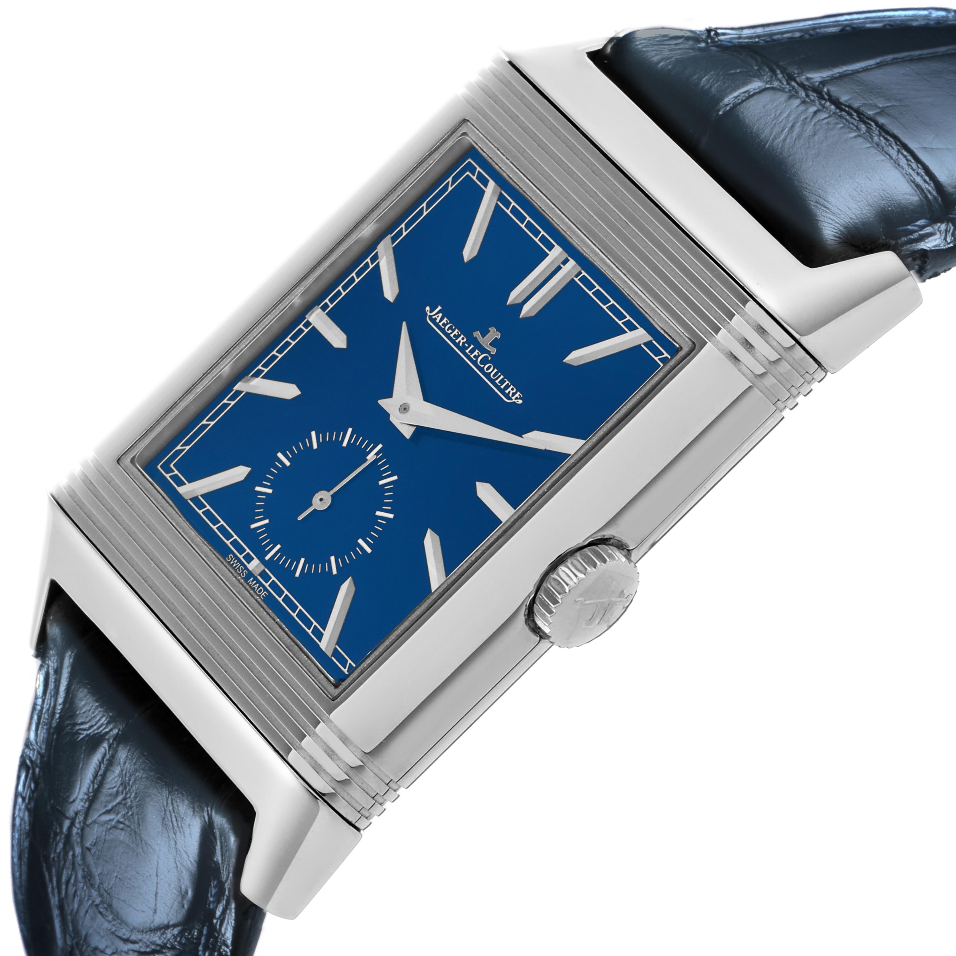 The Jaeger-LeCoultre Reverso watch is shown at an angle highlighting the blue dial, side profile, and crown.