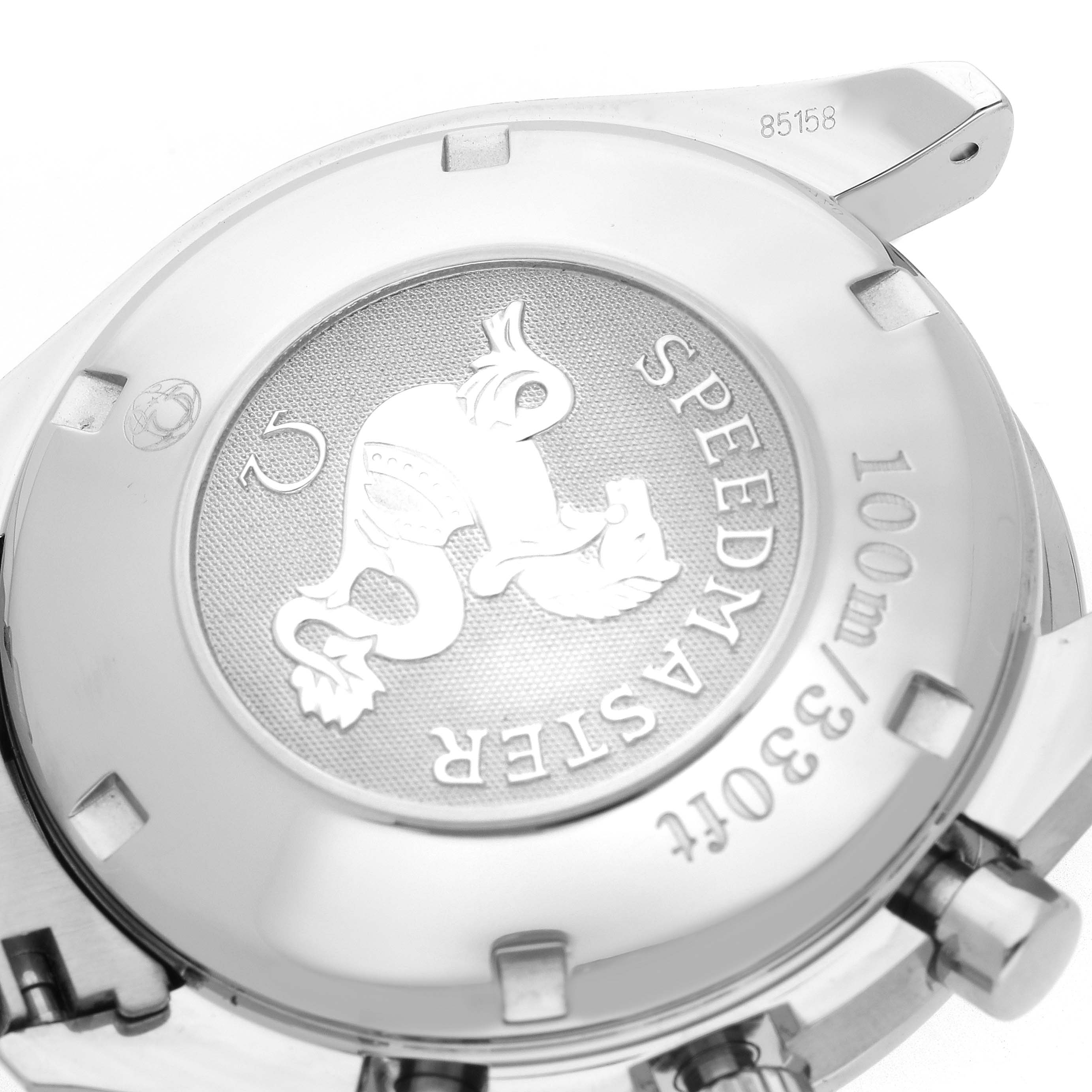 The image shows the Omega Speedmaster 3220.50.00 Men's Stainless Steel Black Dial 3220.50.00 Men's Stainless Steel Black Dial's case back at an oblique angle, highlighting its engraved design and branding.