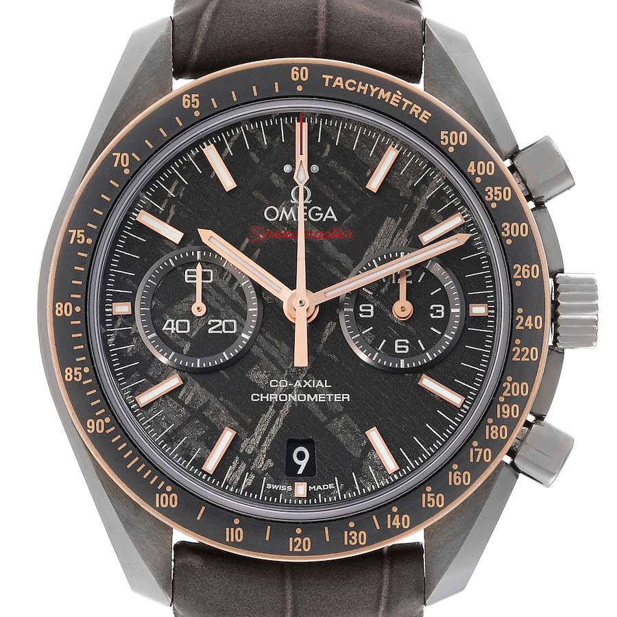 The image shows a front view of an Omega Speedmaster watch face, highlighting the dial, sub-dials, tachymeter, and crown.