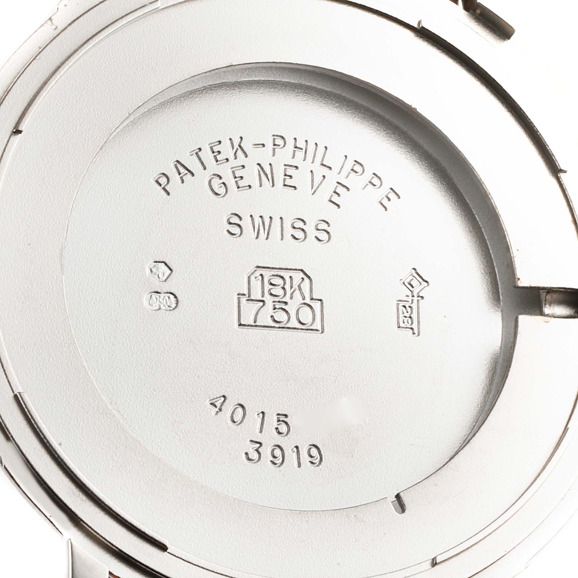 The image shows the back case of a Patek Philippe Calatrava 3919G Men's White Gold White Dial 3919G Men's White Gold White Dial watch, including engravings of brand details and gold purity marks.