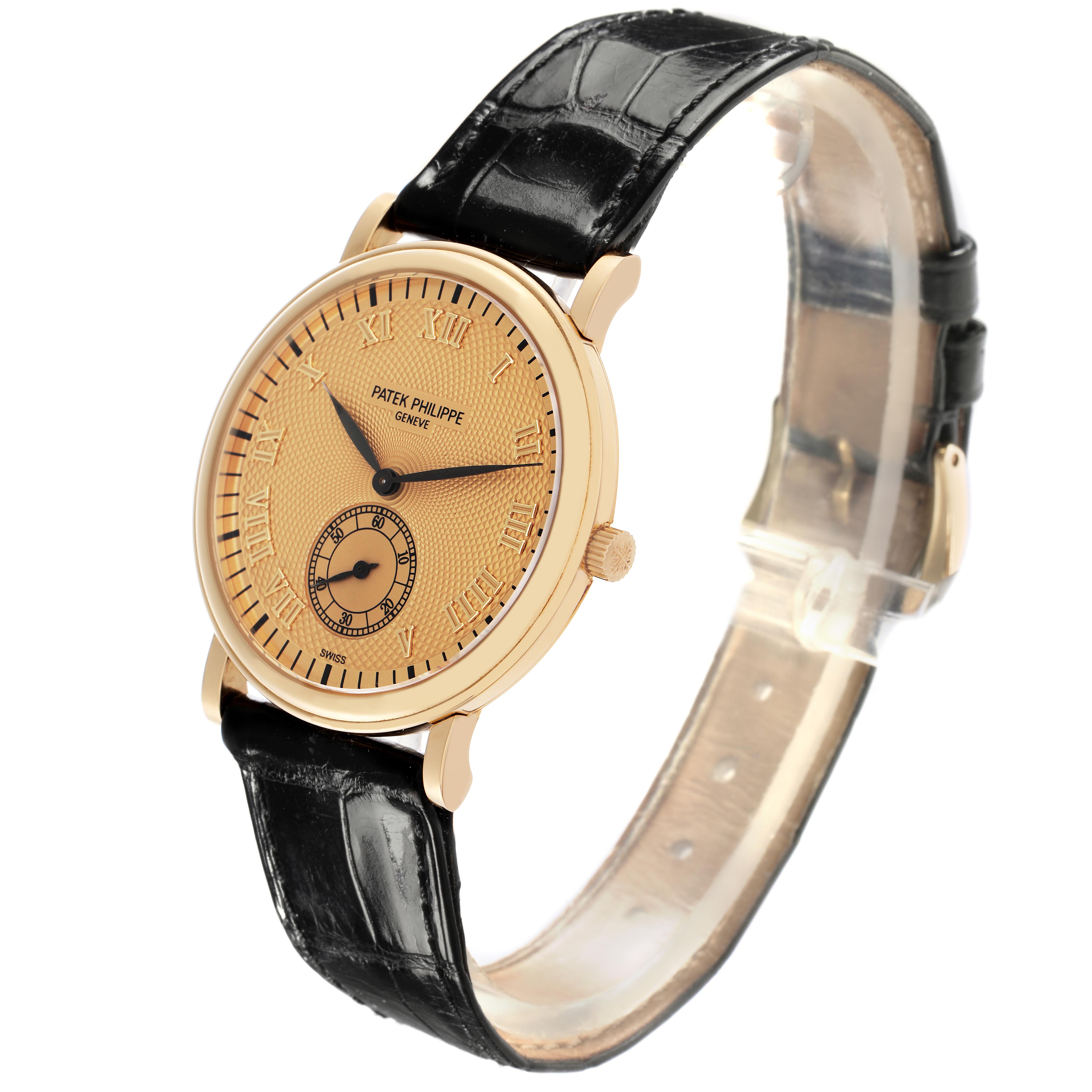 The Patek Philippe Calatrava 5022J-001 Men
s Yellow Gold Champagne Dial 5022J-001 Men
s Yellow Gold Champagne Dial watch is shown at a slight side angle, displaying the face, crown, and leather strap.