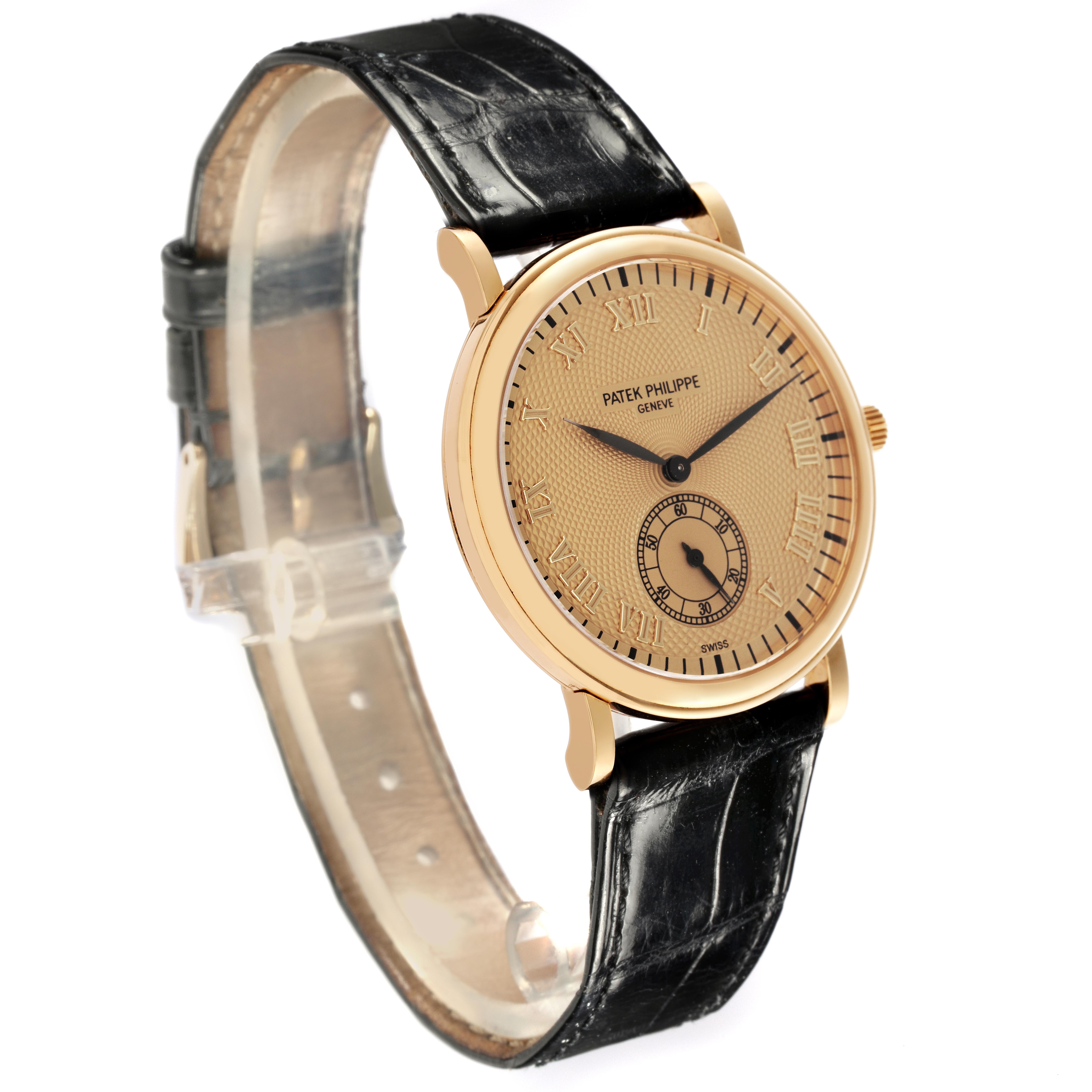 The Patek Philippe Calatrava 5022J-001 Men
s Yellow Gold Champagne Dial 5022J-001 Men
s Yellow Gold Champagne Dial watch is shown at a three-quarter angle, displaying the face, case, and strap.