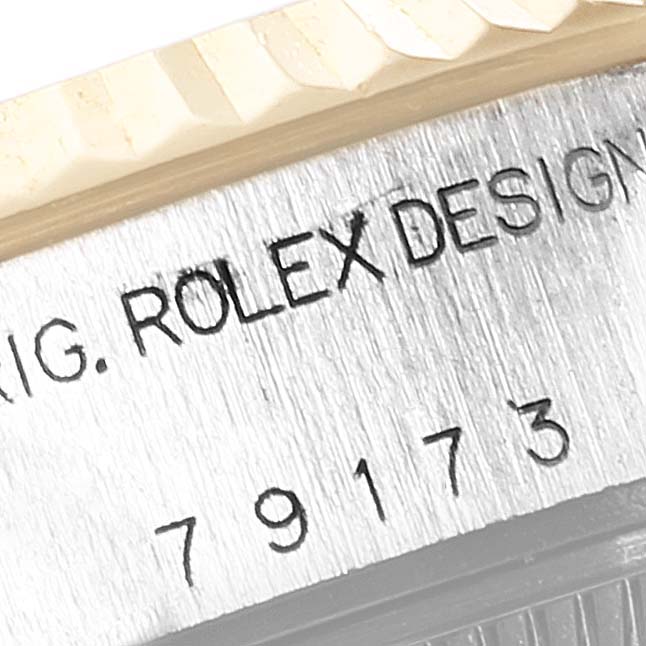 This close-up image shows the serial number and part of the bezel and case side of a Rolex Datejust 79173 Women's Steel and Gold (two tone) White Dial 79173 Women's Steel and Gold (two tone) White Dial watch.