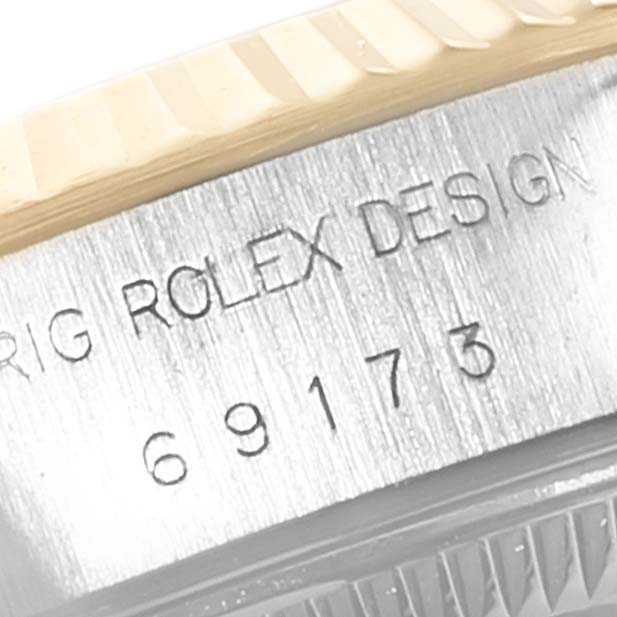 This image shows a close-up of the serial number inscribed on the side of the Rolex Datejust 69173 Women's Steel and Gold (two tone) White Dial 69173 Women's Steel and Gold (two tone) White Dial watch case.