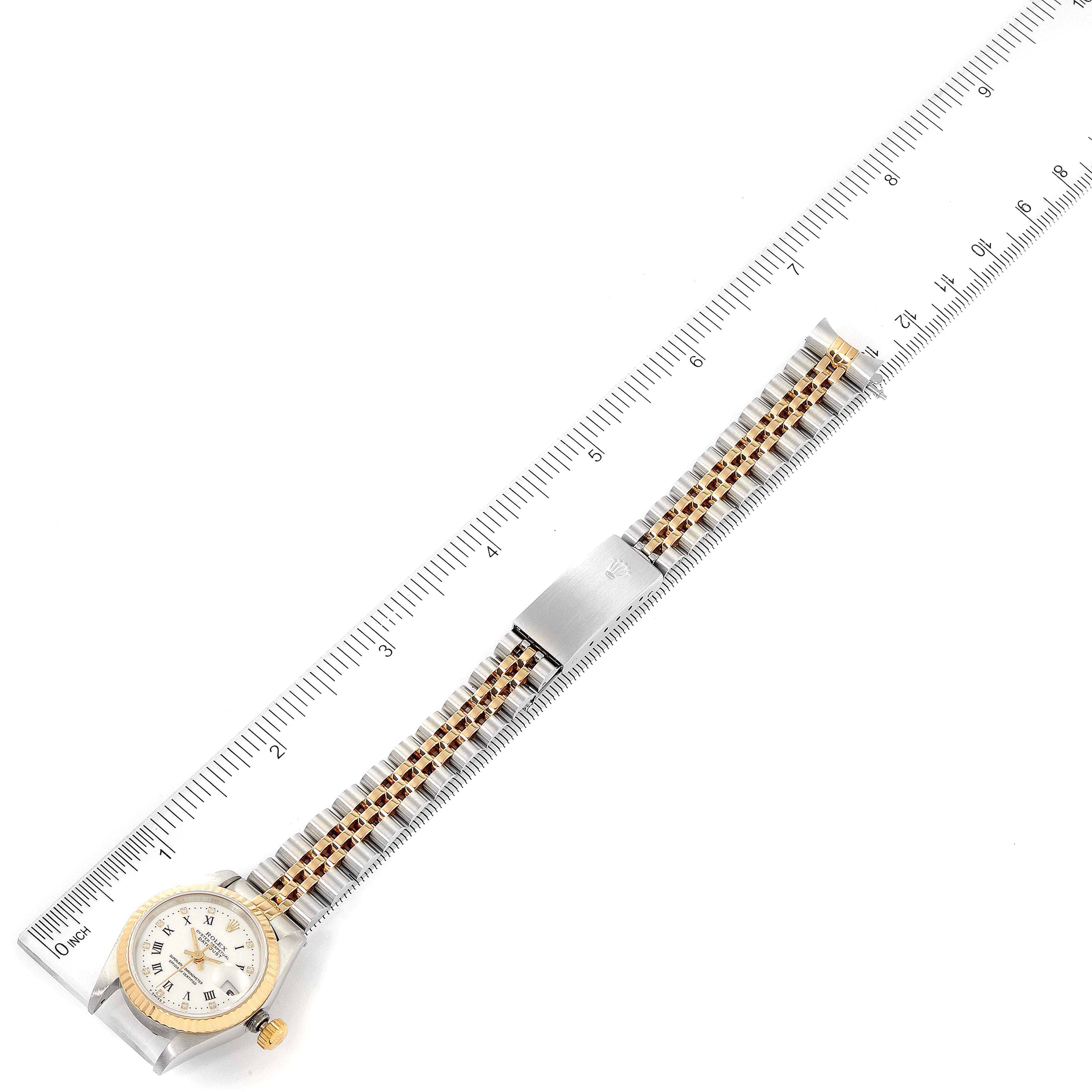 The image shows a Rolex Datejust 69173 Women's Steel and Gold (two tone) White Dial 69173 Women's Steel and Gold (two tone) White Dial watch laid flat alongside a ruler, displaying the entire band and face from an overhead angle.