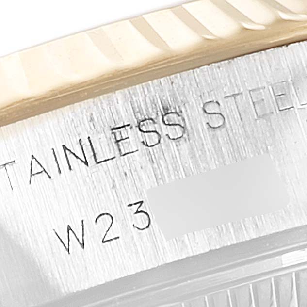 This is a close-up of the side of a Rolex Datejust 69173 Women's Steel and Gold (two tone) White Dial 69173 Women's Steel and Gold (two tone) White Dial watch, showing the stainless steel engraving and part of the fluted bezel.