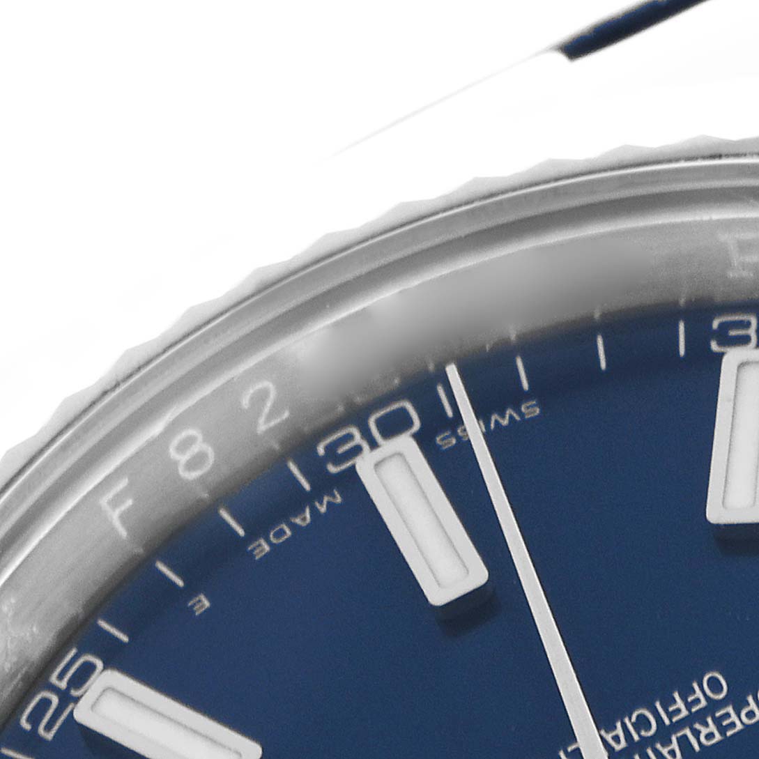 The image shows a close-up of the Rolex Datejust 116139 Men
s White Gold Blue Dial 116139 Men
s White Gold Blue Dial watch
s dial and bezel, focusing on the hour markers and minute indicators.