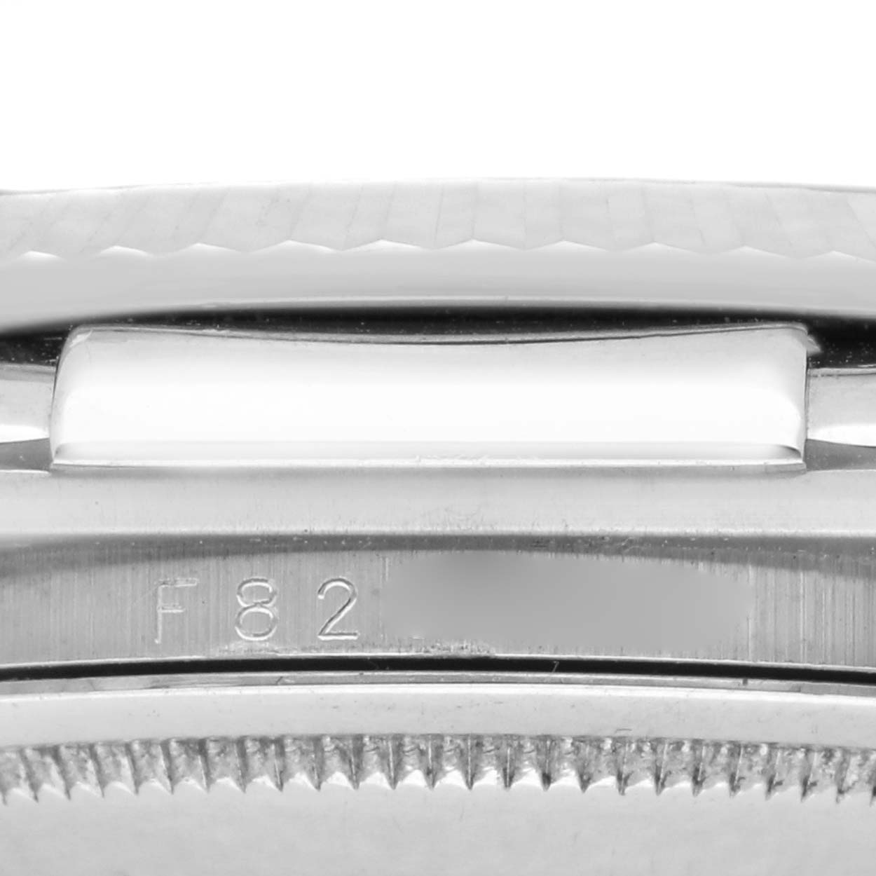 The image shows a close-up of a Rolex Datejust 116139 Men
s White Gold Blue Dial 116139 Men
s White Gold Blue Dial watch, focusing on the side view with a partial bracelet and serial engraving.