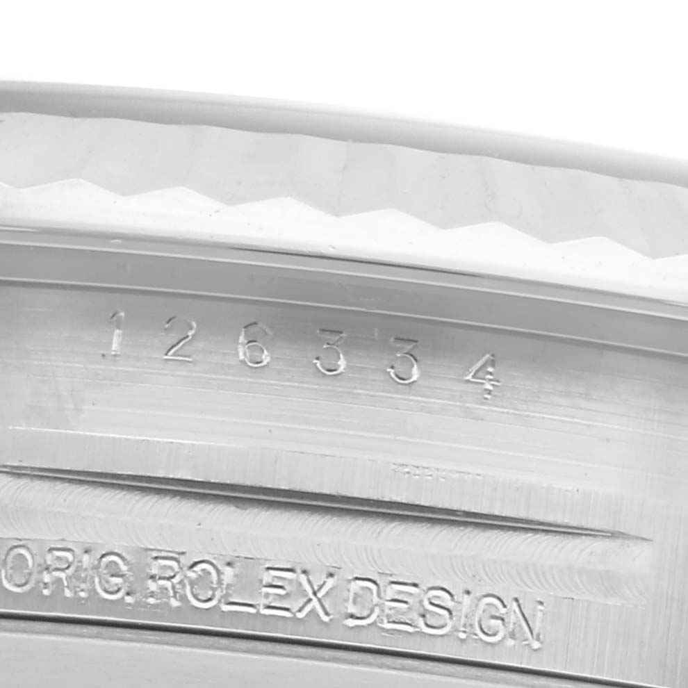The image shows the engraved inner bezel of a Rolex Datejust 41 126334 Men
s Stainless Steel White Dial 126334 Men
s Stainless Steel White Dial, focusing on the serial number and "Orig Rolex Design."